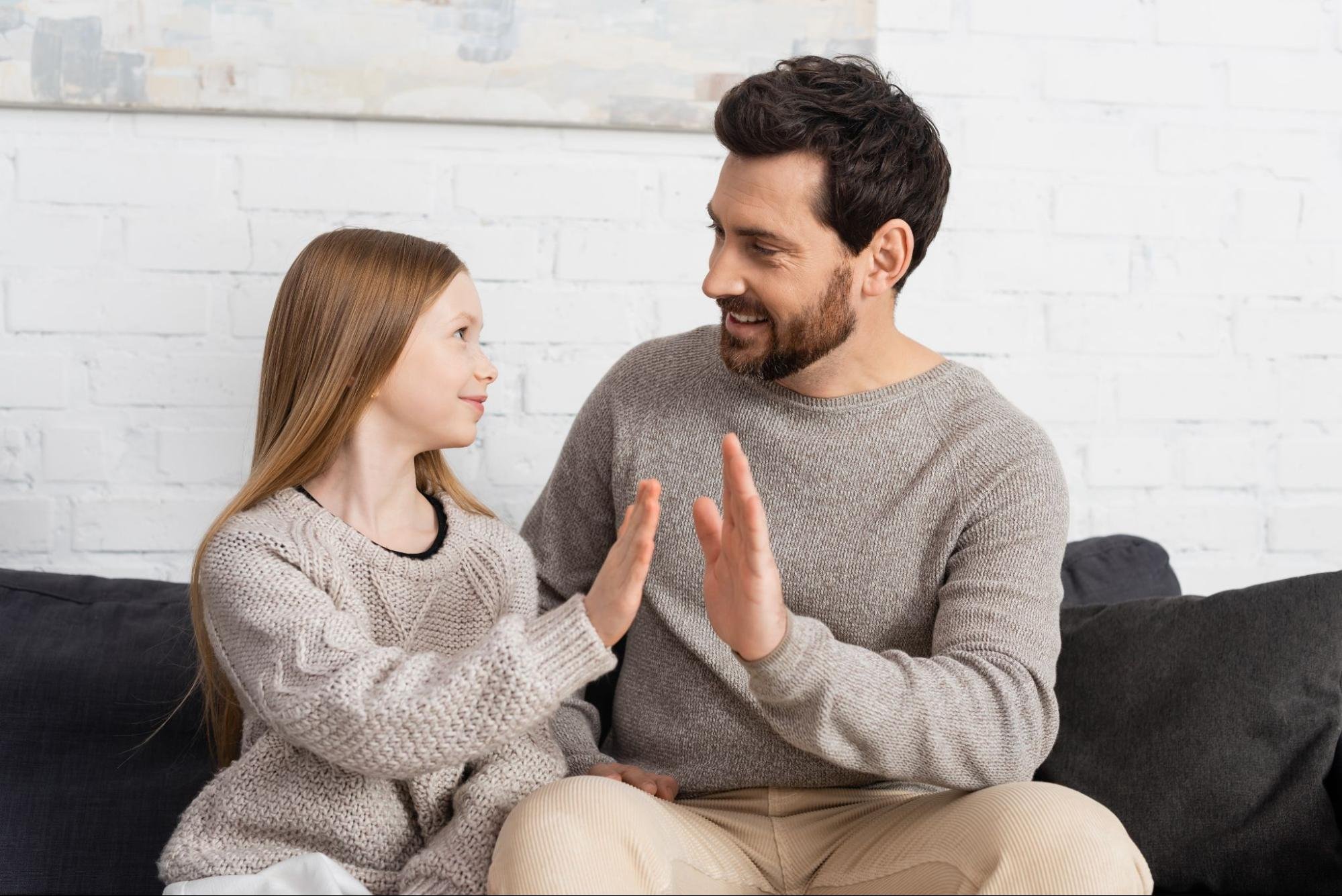 Father giving his daughter a high-five.
