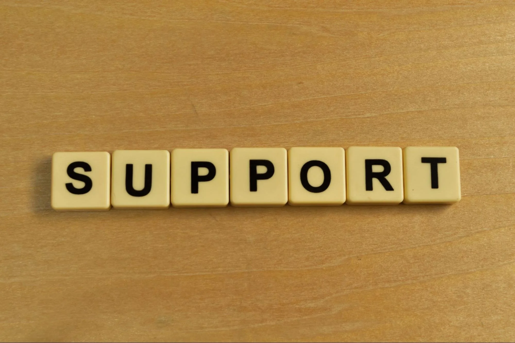 Word “SUPPORT” on word tiles. 