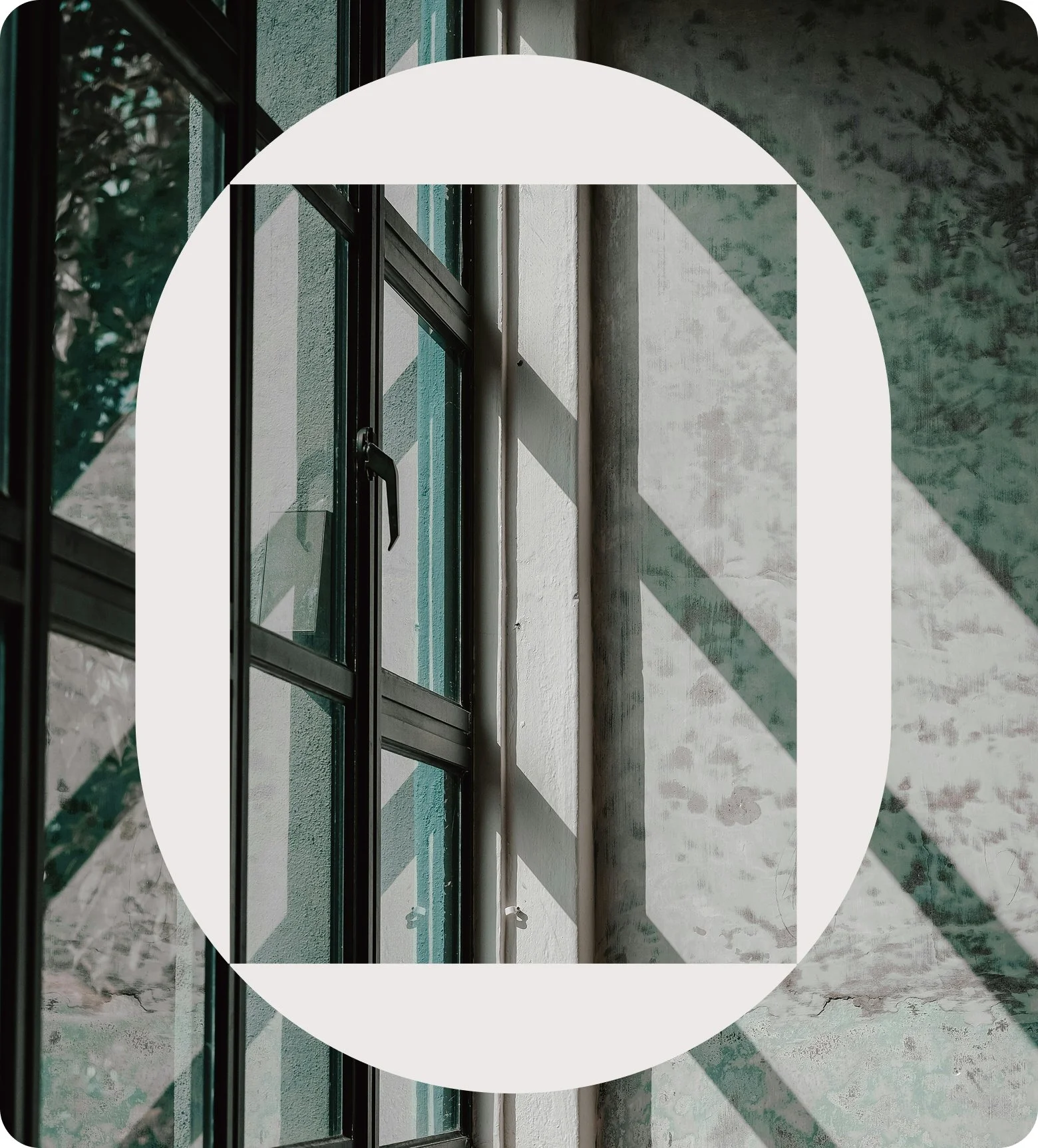 A window with a black frame and handle, casting shadows on a white wall outside. The wall has a textured surface and is partially painted with teal. There is also a vertical white pipe attached to the wall.