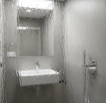 Steam-covered shower door with built-in shelves and a faucet handle