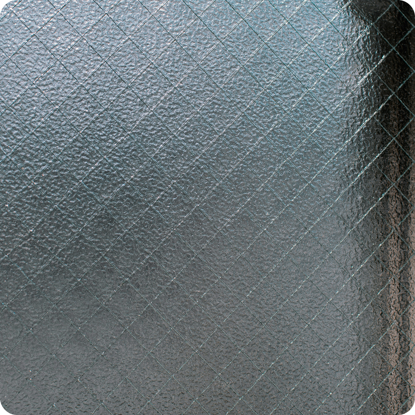 Close-up of a textured, gray, frosted glass surface with a grid-like pattern of intersecting lines.