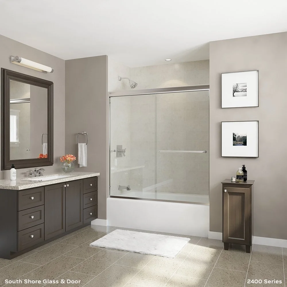 Modern bathroom with gray and beige colors, featuring a vanity with a mirror, a glass-enclosed shower, and wall art