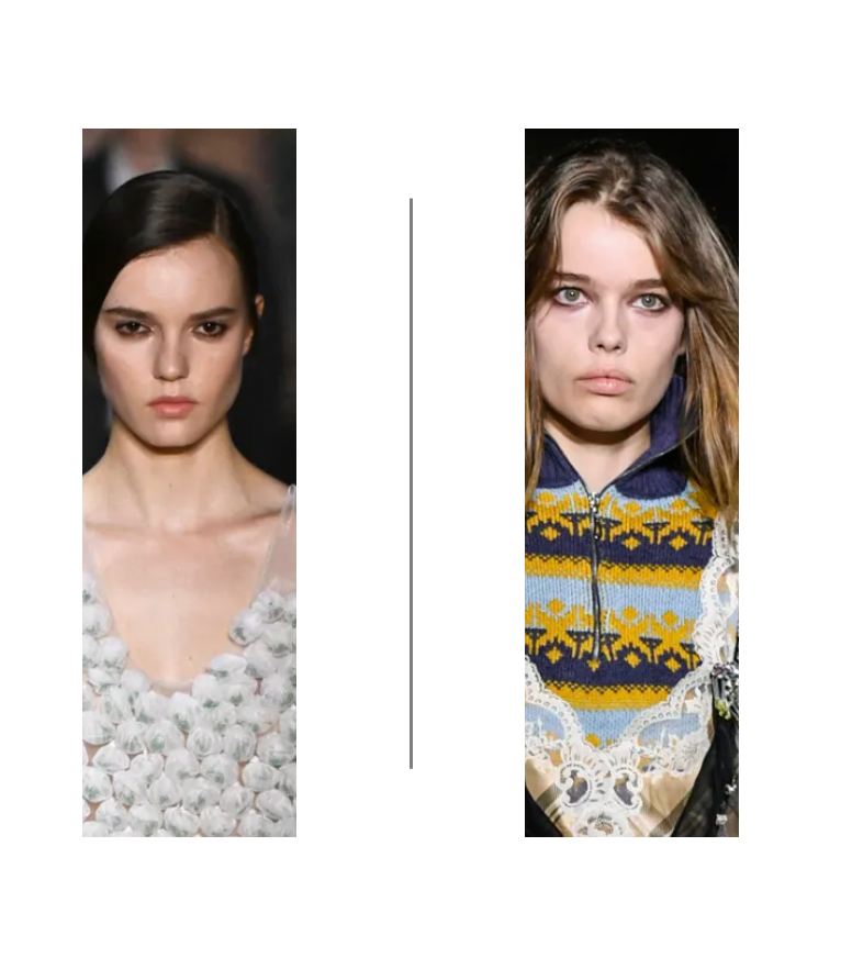 Two women with serious expressions, one with dark hair wearing a floral dress, the other with light hair wearing a patterned sweater with lace details.