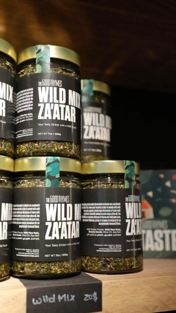 Shelves of jars labeled 'Wild Mix Za'atar' in a store, with a sign indicating the price as 20 cents.