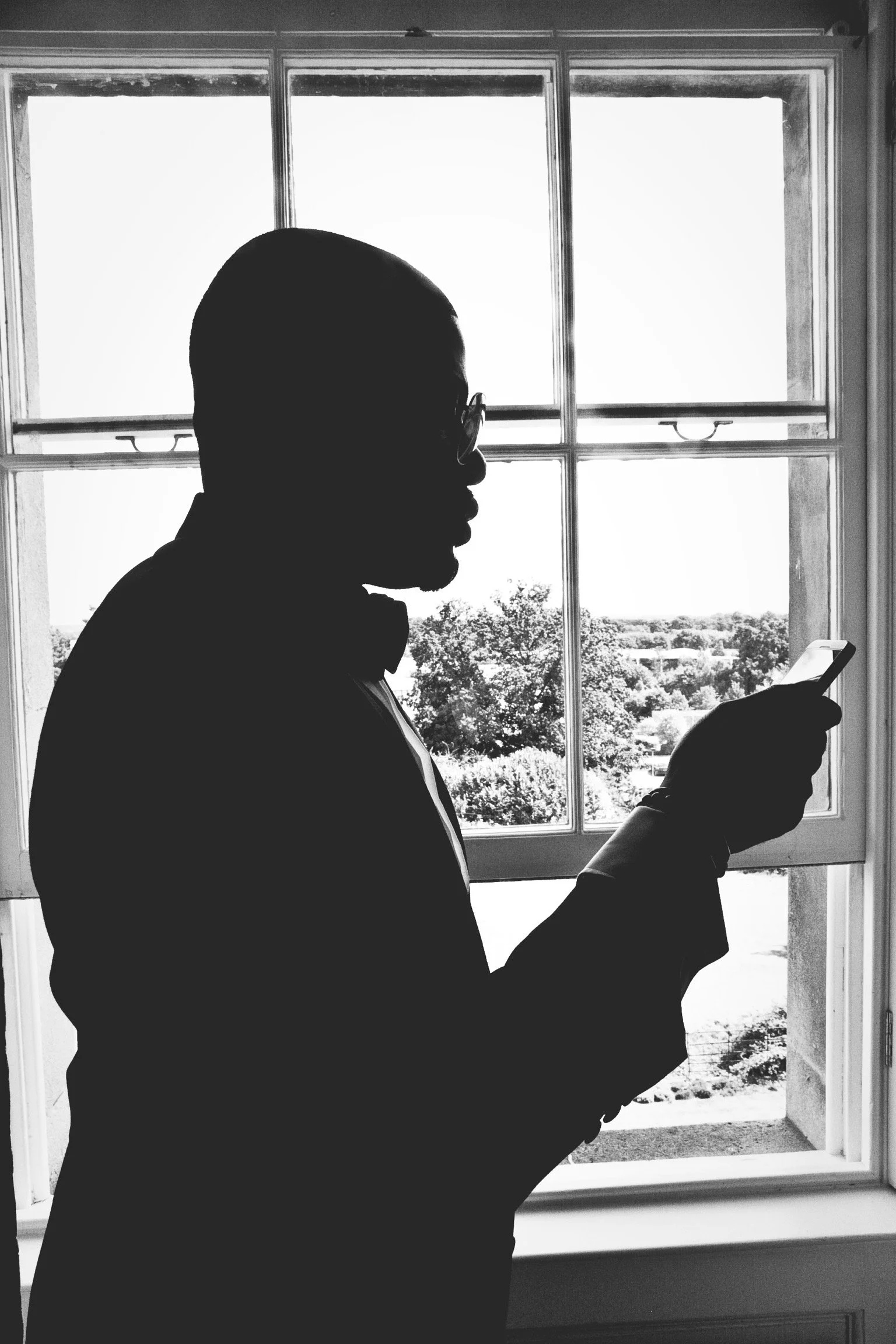 Black and white Wedding image of groom in silhouette in London by G’Safe Exposure Greenwich London