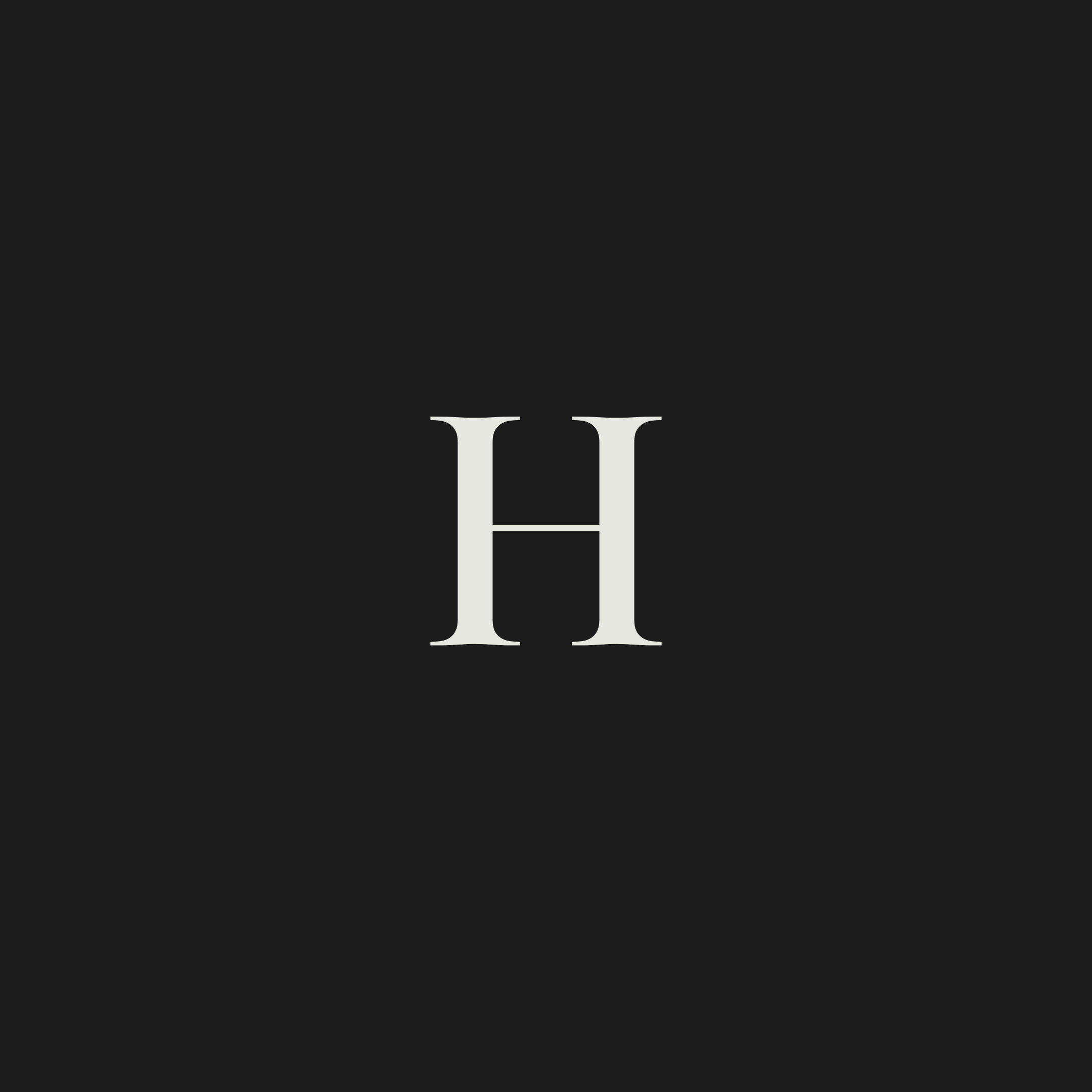Close-up of a black surface with a large white H