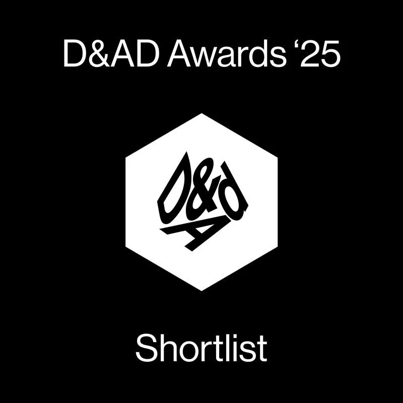 Black digital graphic with white text reading "D&AD Awards '25" at the top and "Shortlist" at the bottom. In the center, a white hexagon contains a stylized black "D&AD" logo.