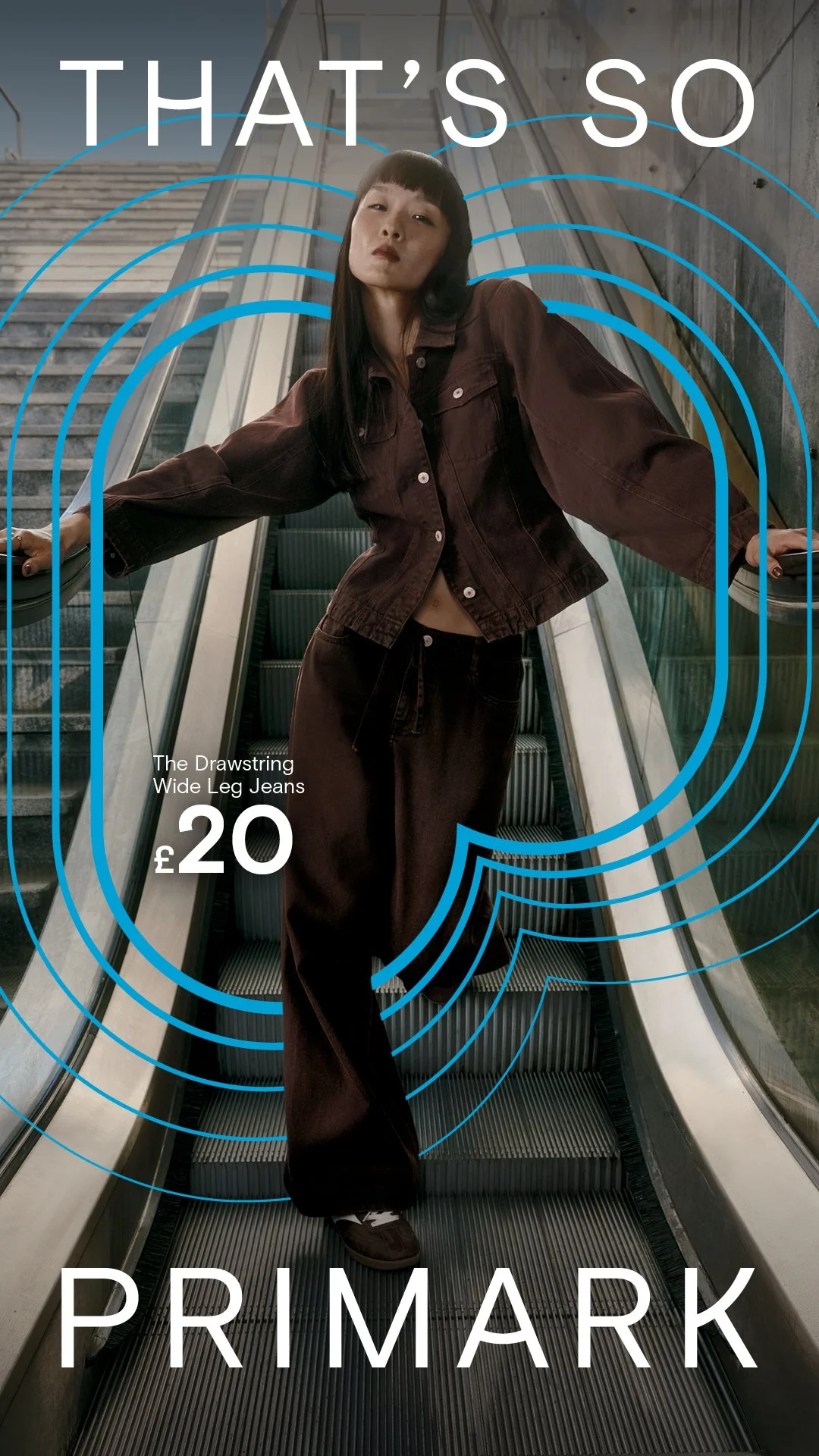A woman standing on an escalator inside a modern building, wearing a brown jacket and wide-leg jeans, with blue graphic lines and white text promoting Primark's wide leg jeans for £20.