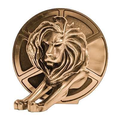 Close-up of a lion sculpture with a mane, resting its head against a circular background, possibly a decorative piece.