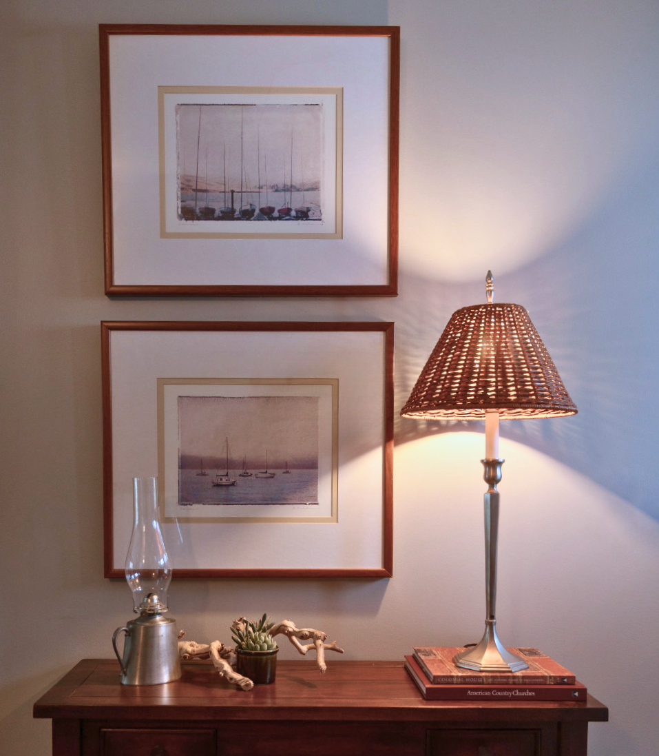 Entry table with custom boating art welcomes guests and sets the tone of the home. Featherstone Interior Design. Pulled together homes without the luxury price tag.