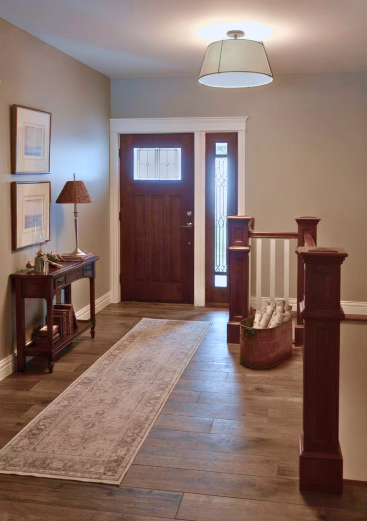 Craftsman style home features design elements in the entry that set the feel for the relaxed style of the entire home. Wood details show the craftsman theme. Featherstone Interior Design, pulled together homes without the luxury price tag.