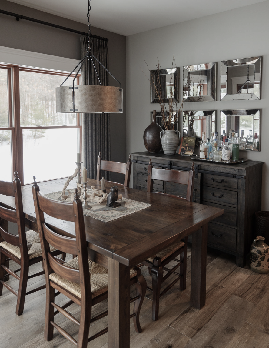 Casual Dining Room with custom window treatments. Rustic dining table and chairs. Hammered metal drum chandelier. Pitted glass mirrors over sideboard.