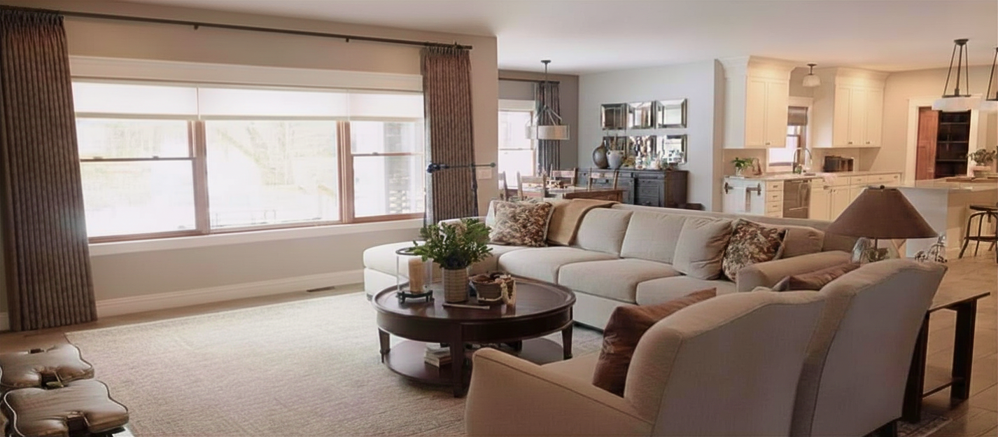 Pulled together homes without the luxury price tag. Transitional open space with neutral decor. Craftsman kitchen lighting; ivory kitchen, window treatments and custom furniture.