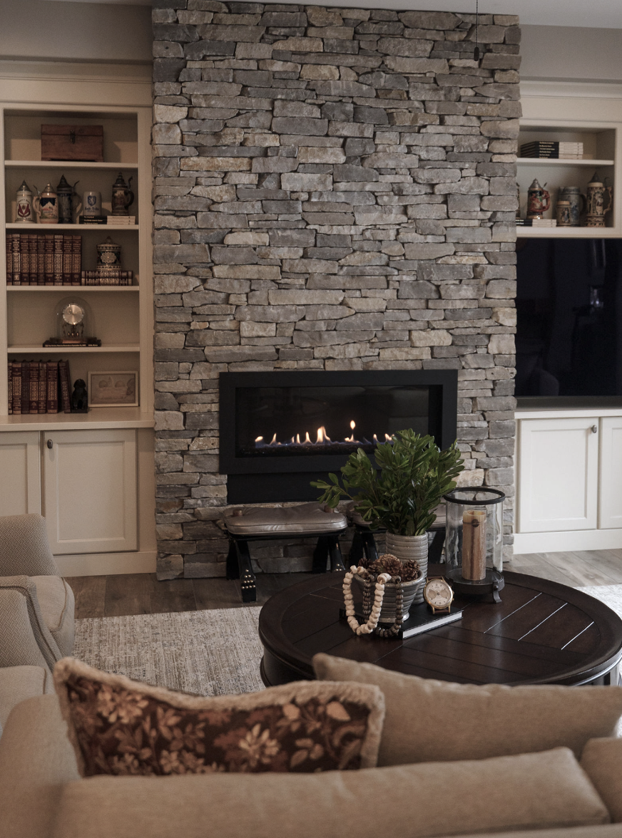 Stacked stone linear firelplace box. Built in cabinetry in transitional style living room. Featherstone Interior Design. Pulled together homes without the luxury price tag.