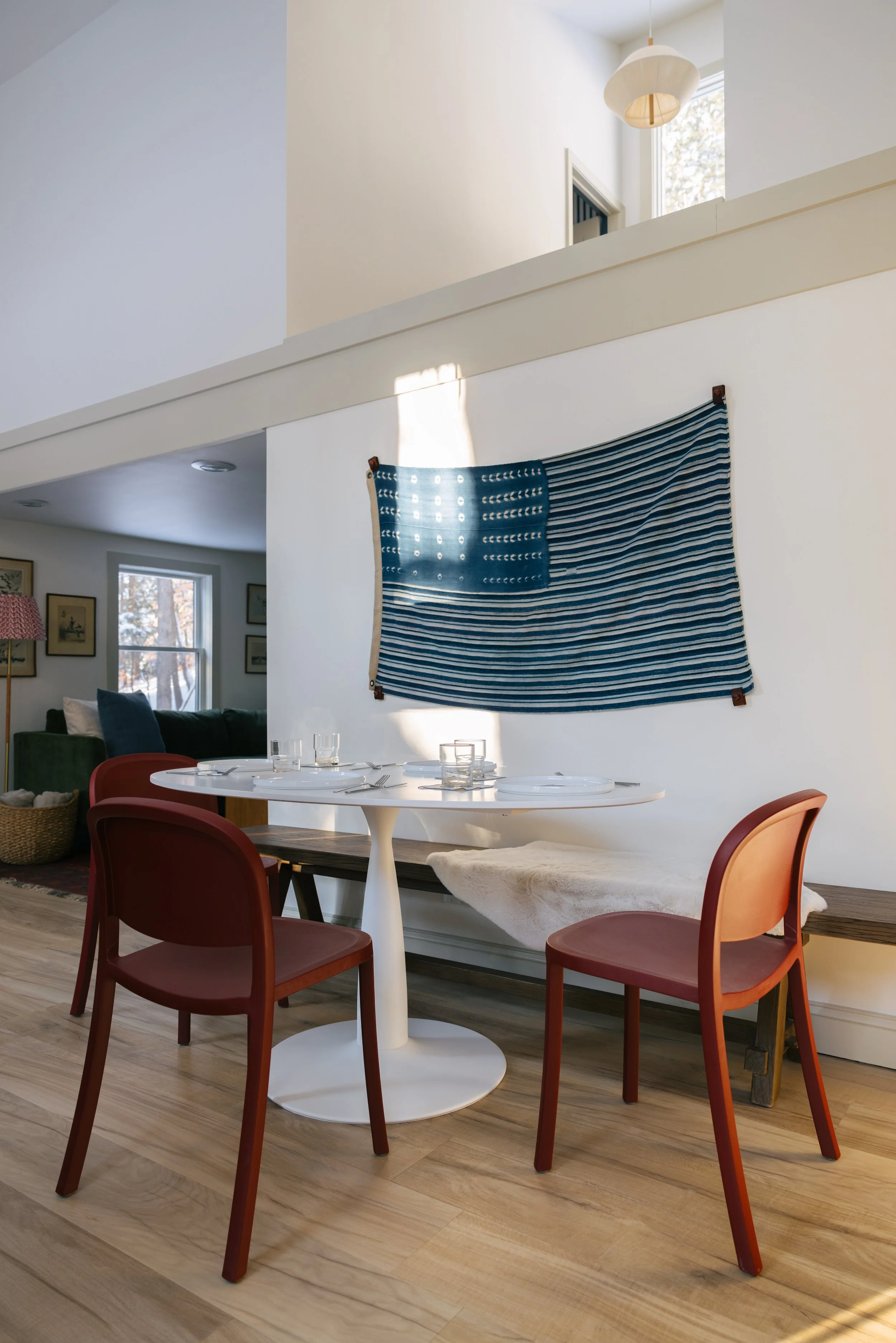 Bright dining area at Pine & Plaid Vermont cabin rental with round table seating, natural light, and space for family meals near The Quechee Club.