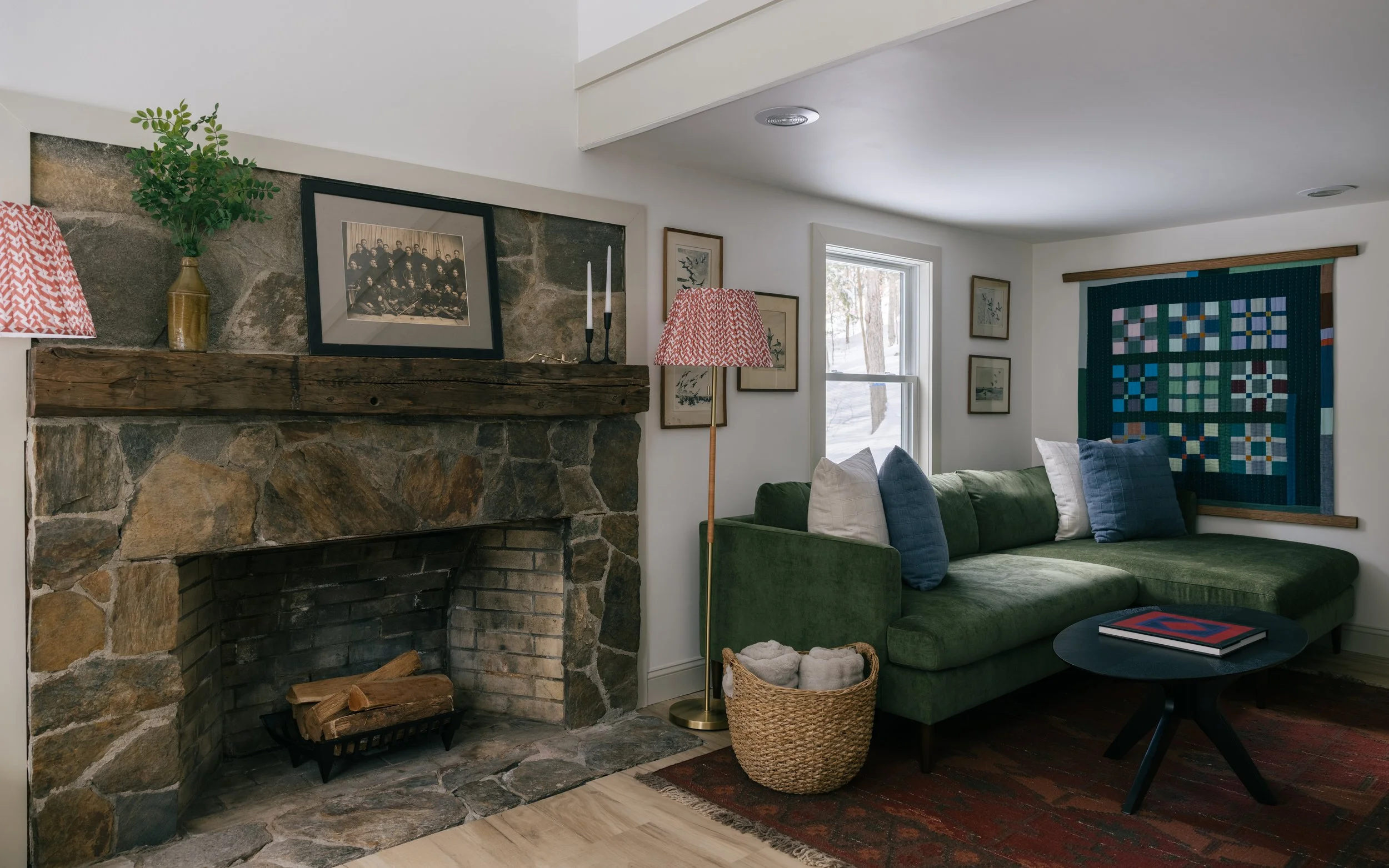 Living room at Pine & Plaid cabin rental in Quechee, Vermont with stone fireplace and cozy seating.