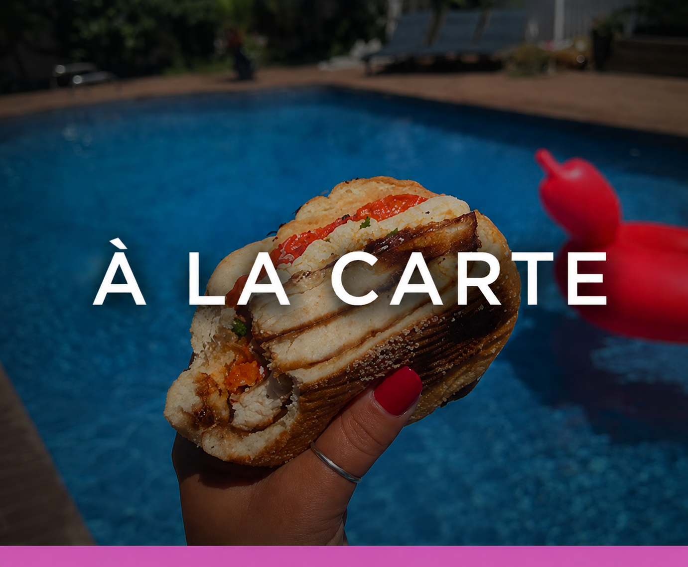 A person holding a sandwich with grilled chicken, roasted red peppers, mozzarella, and balsamic.
