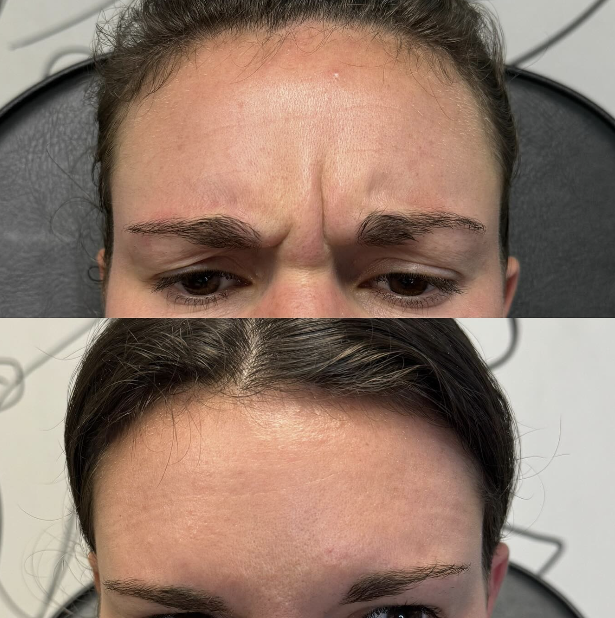 A ceramic vase with a single dried branch sits on a wooden surface, illuminated by natural light creating shadows against a plain wall.