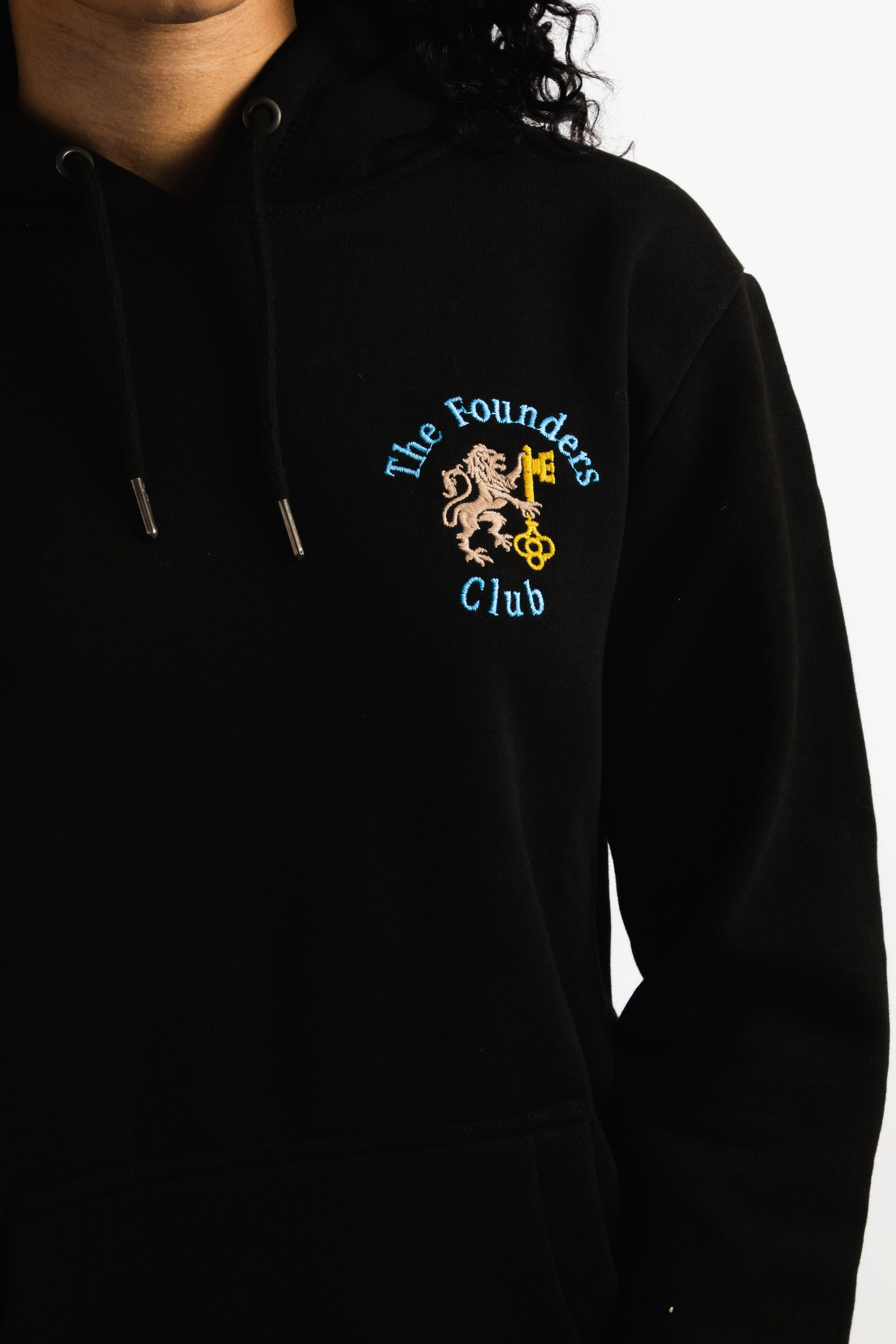 Black hoodie with an embroidered logo of a lion holding a key, with the text "The Founders Club" in light blue.