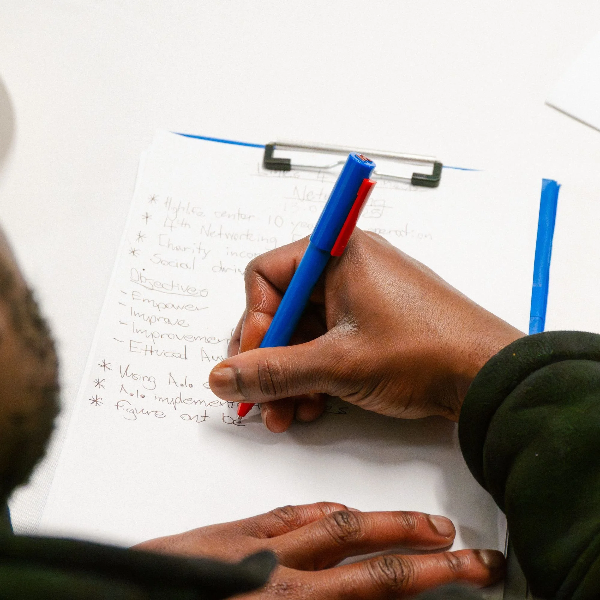 A man taking notes during an event