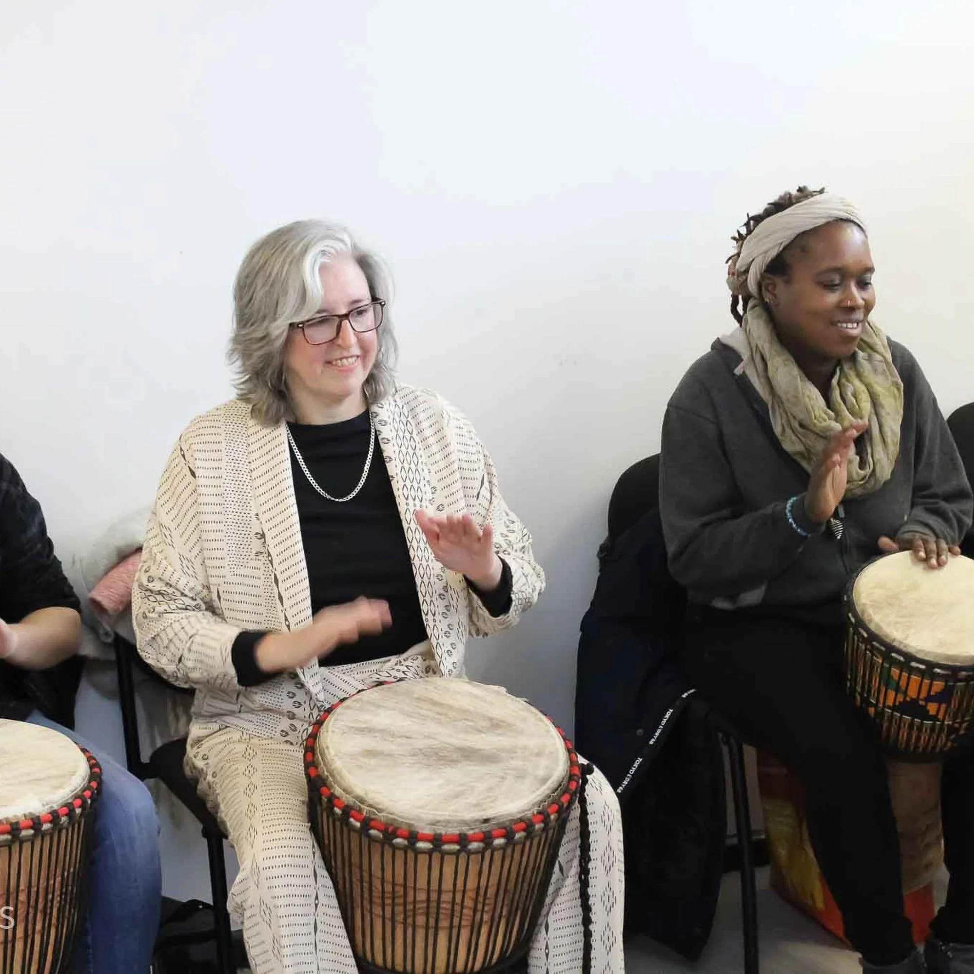 People taking part in a drumming session