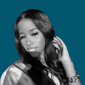 A grayscale portrait of a young woman with long, wavy hair, looking slightly to the side, with a serious expression, against a plain background.