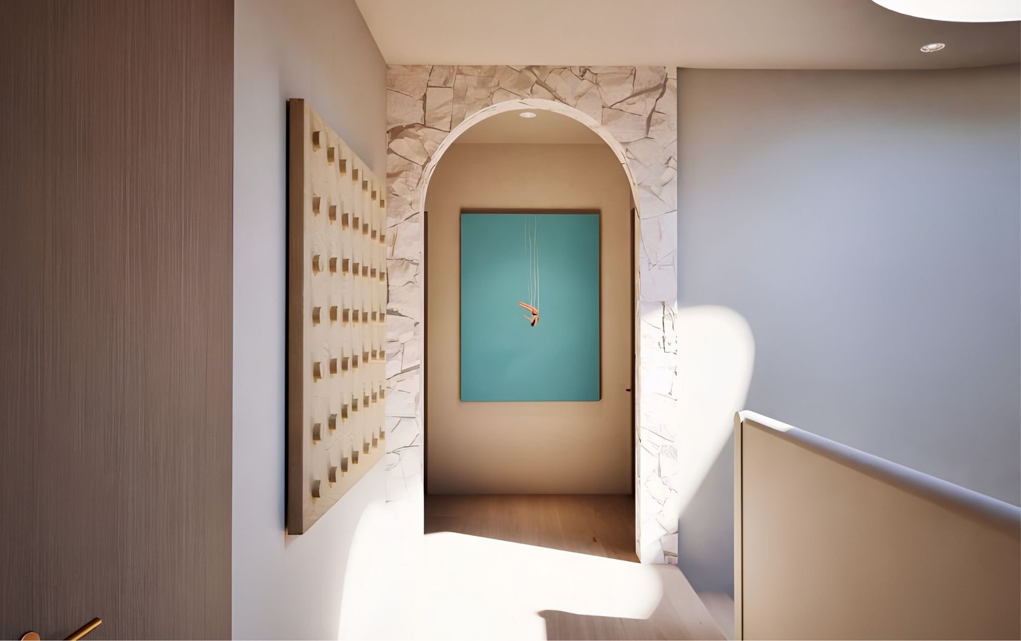 Modern interior space with an arched doorway, a turquoise wall hanging, and a beige textured wall with a marble-like pattern. there is a wooden shelving unit on the left and some light-colored furniture on the right.