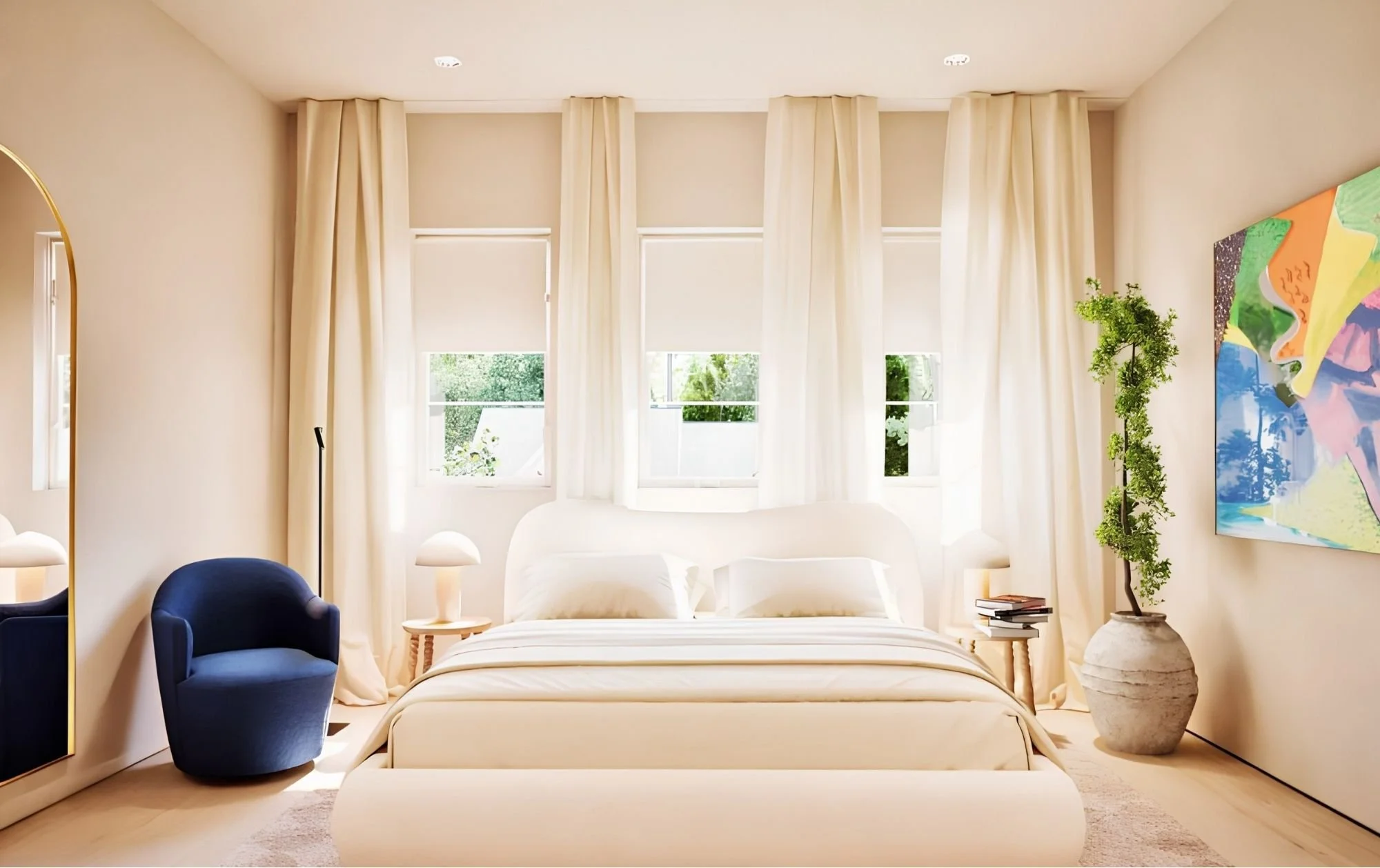Bright bedroom with large windows, cream curtains, white bed, blue chairs, and artwork on the wall.