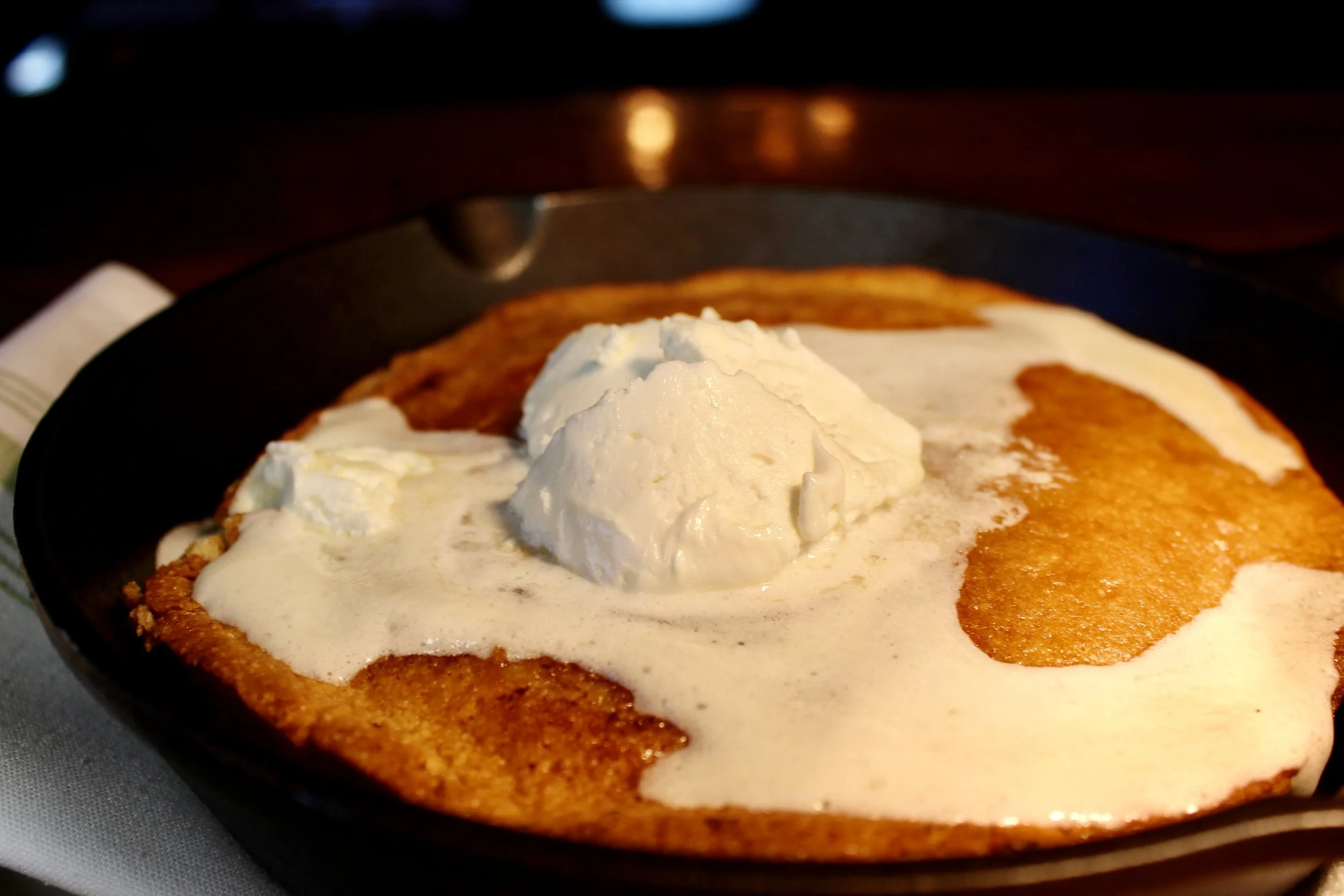 Cornbread topped with melting butter and covered in creamy white gravy.