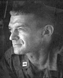 Black-and-white photo of a U.S. military chaplain in uniform, shown in profile and looking to the side
