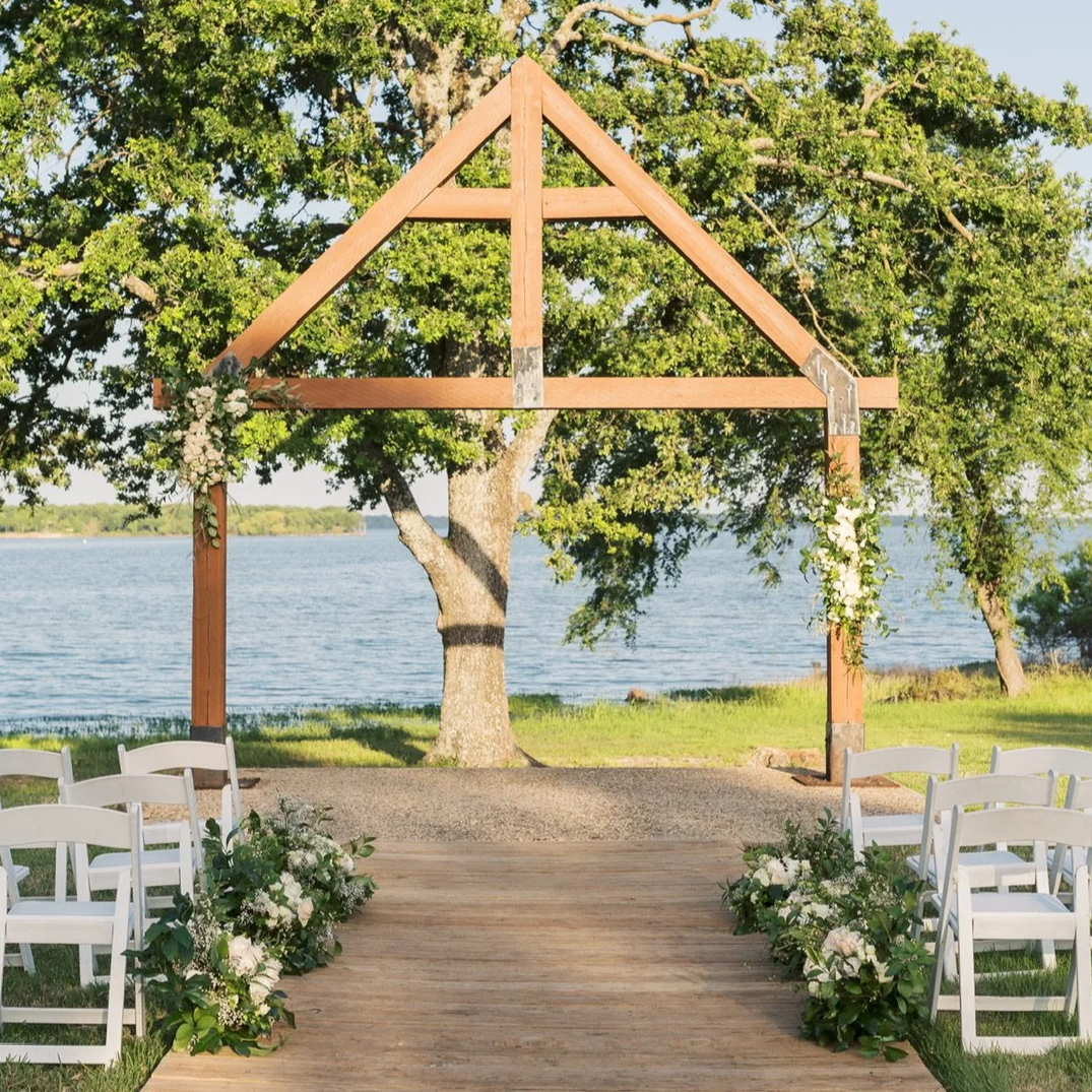 Wedding Ceremony flowers with soft neutral blooms and organic greenery by Dallas wedding florist Izalena Floral House.