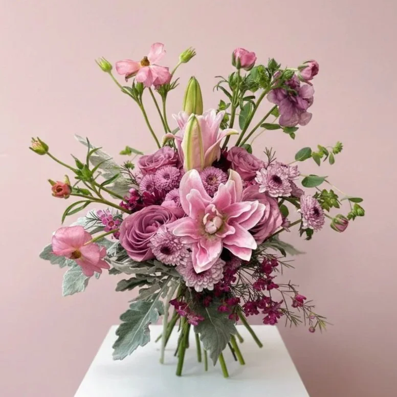 Pink Romantic Floral arrangement and greenery by by Dallas wedding florist Izalena Floral House.