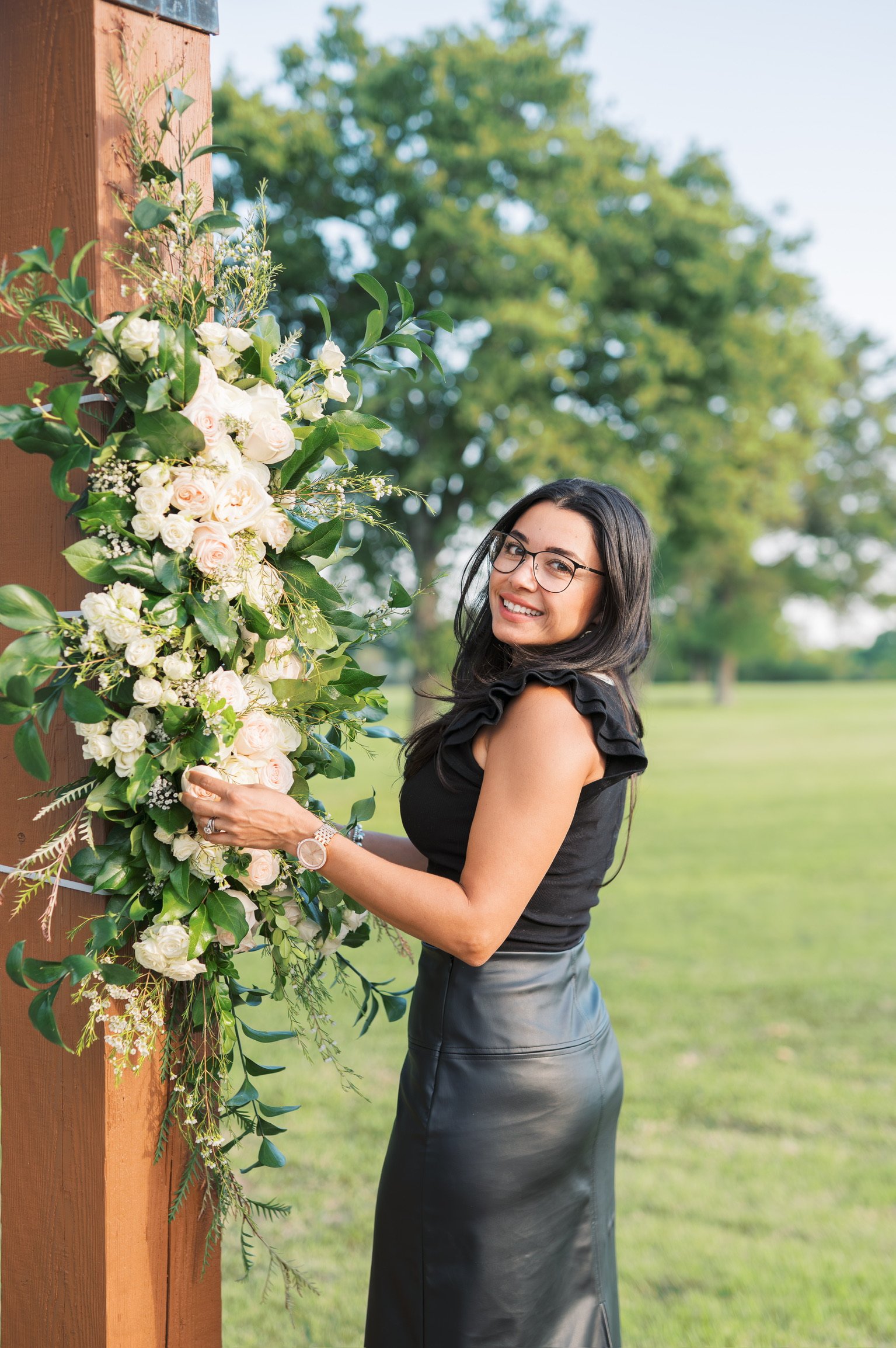 Elegant ceremony arrangement with soft neutral blooms and organic greenery by Dallas wedding florist Izalena Floral House.