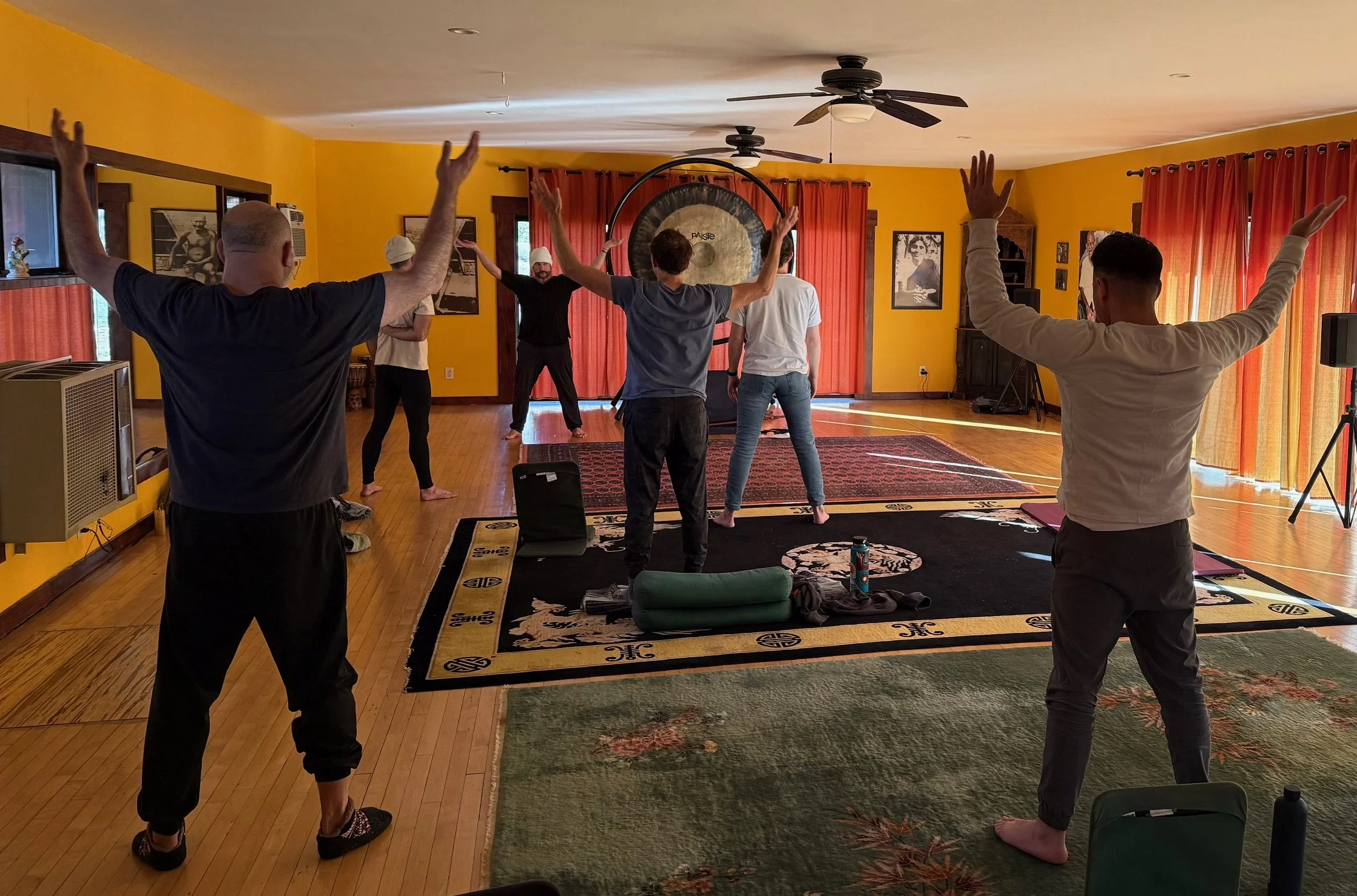 Men practicing breathwork and embodiment exercises in a mens group