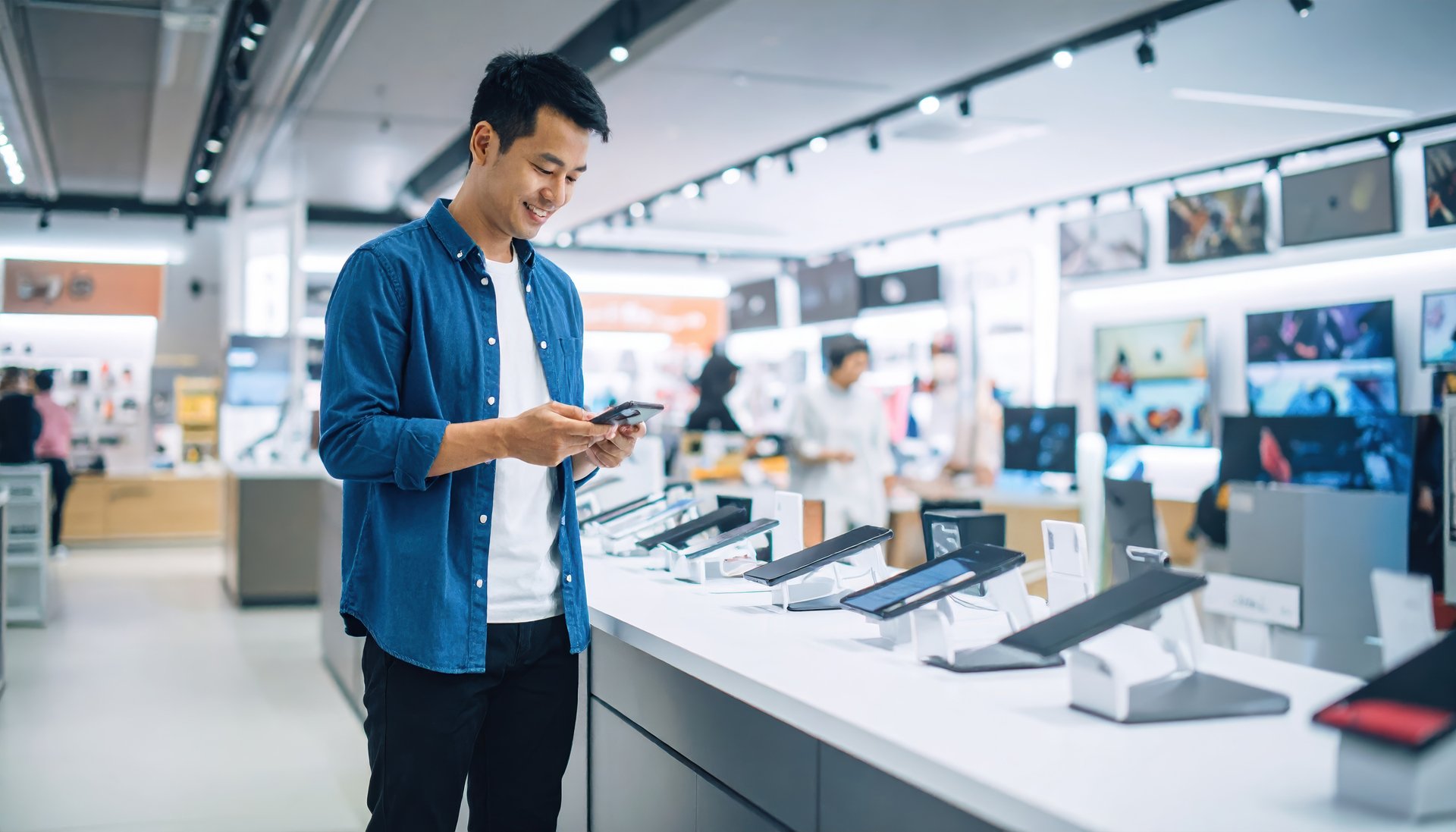 medium-vecteezy_a-man-standing-in-a-store-looking-at-his-phone_74135109_medium.jpg