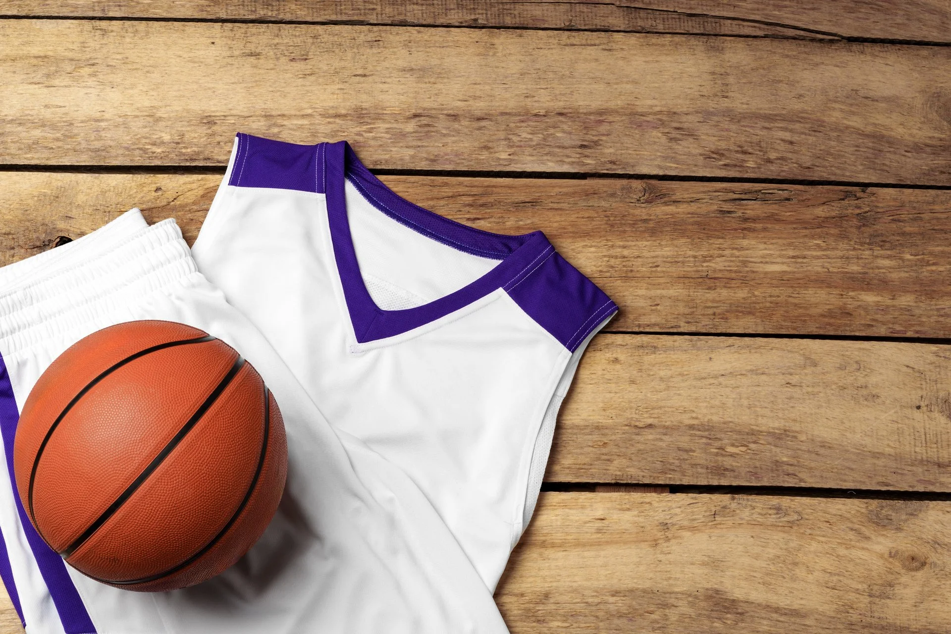 medium-vecteezy_basketball-uniform-on-wooden-background-top-view_50673465_medium.jpg