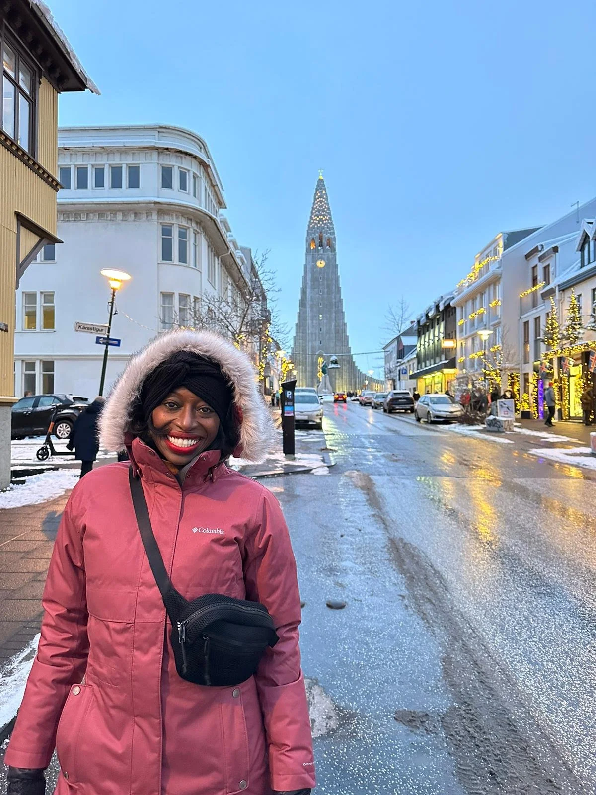 Black woman standing on a snow street in Iceland