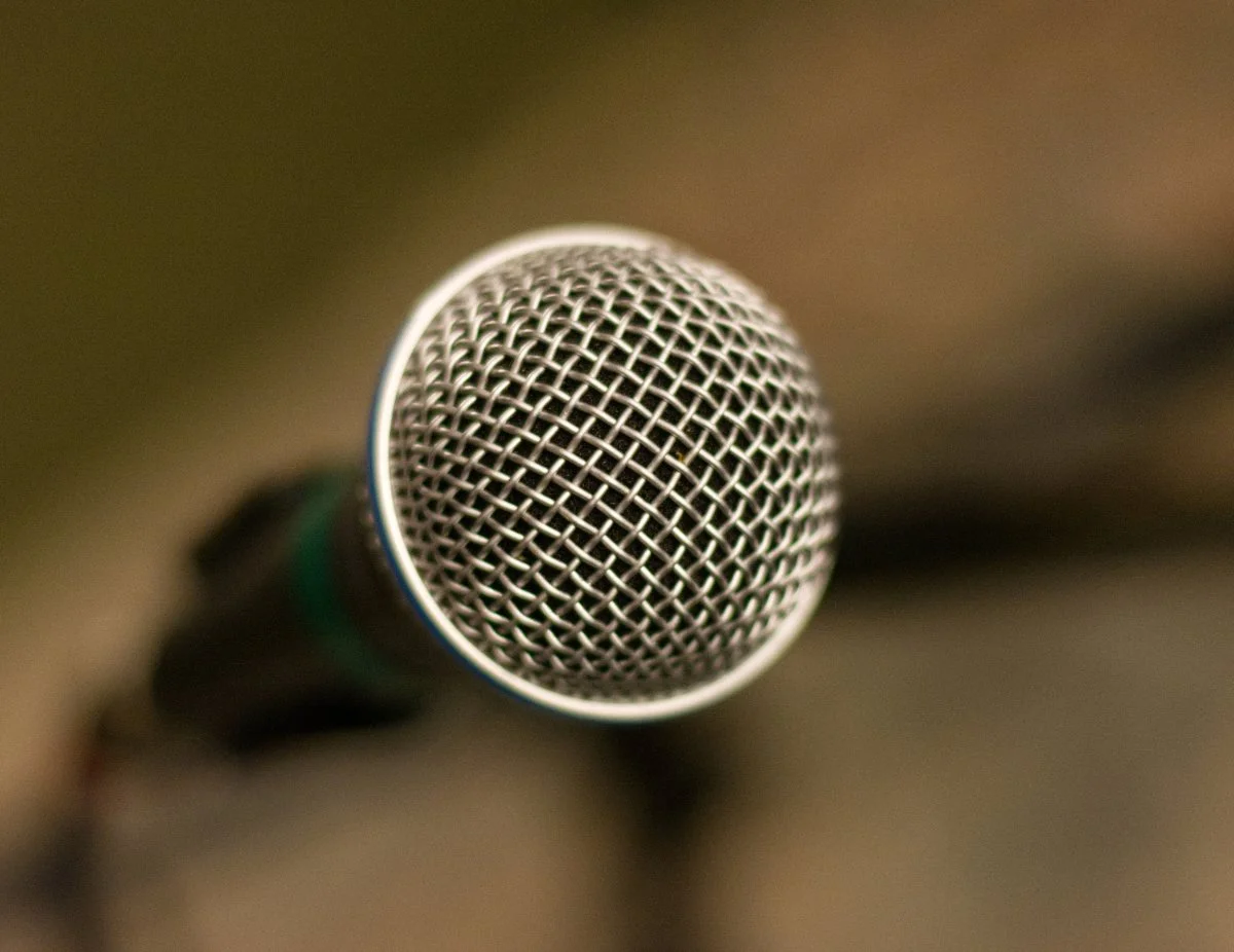 Close-up of a microphone with a metallic grille.