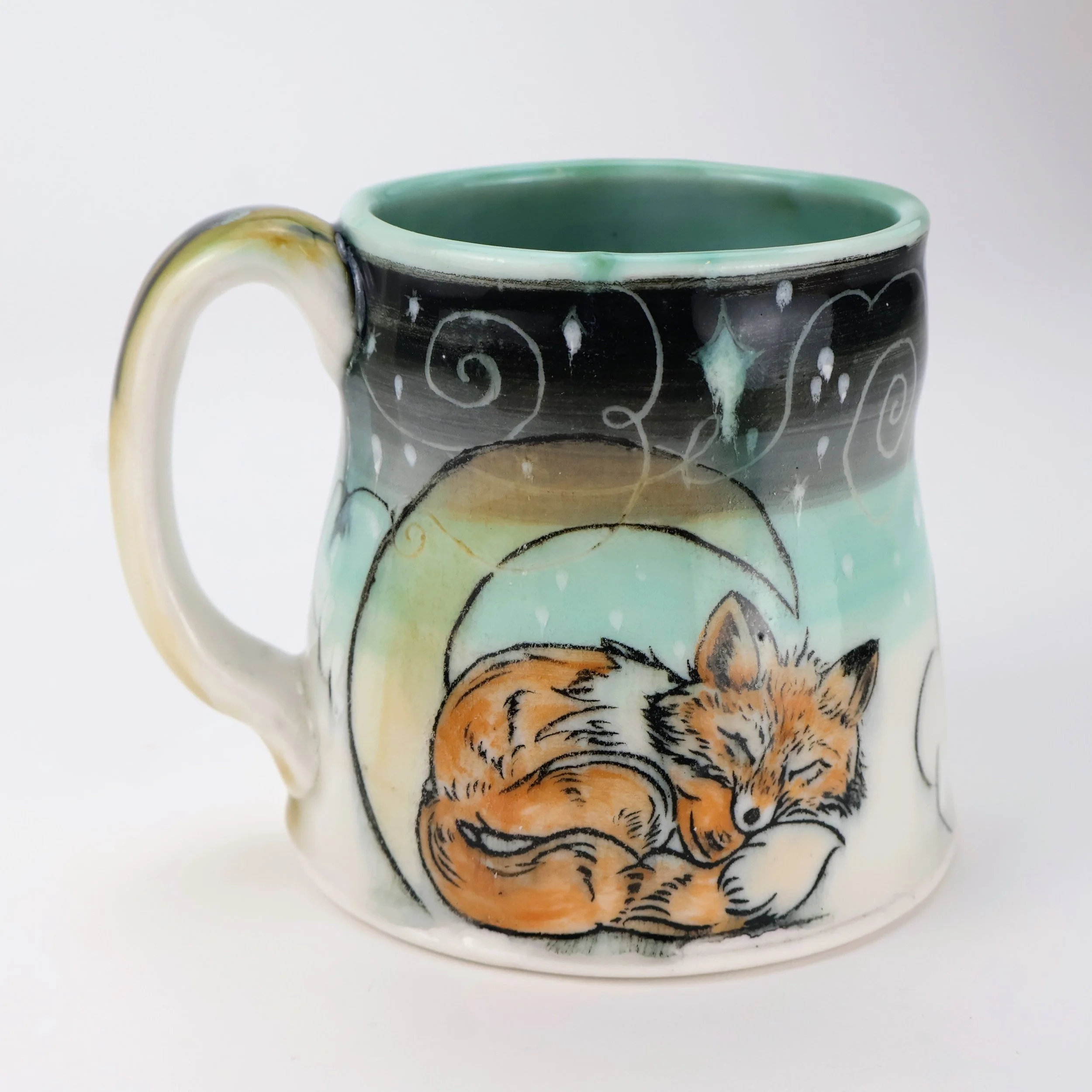 Ceramic mug with Mishima and underglaze painting design of a sleeping fox curled up and resting, surrounded by abstract swirling patterns in soft pastel colors.