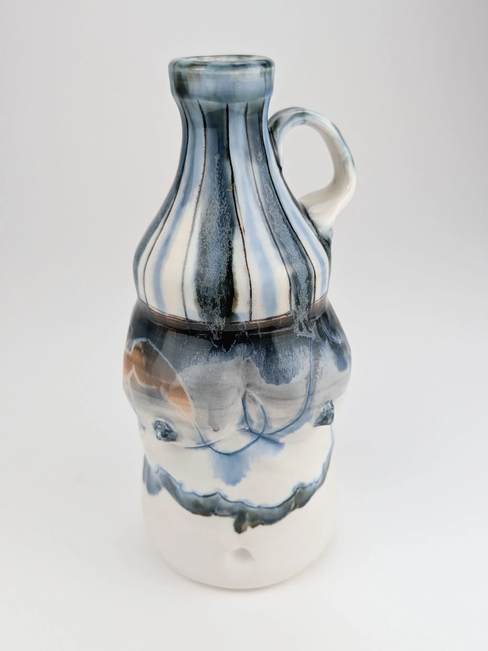 Ceramic porcelain figurative Bottle, with inlayed cobalt Mishima, layered glazes, and underglaze.
