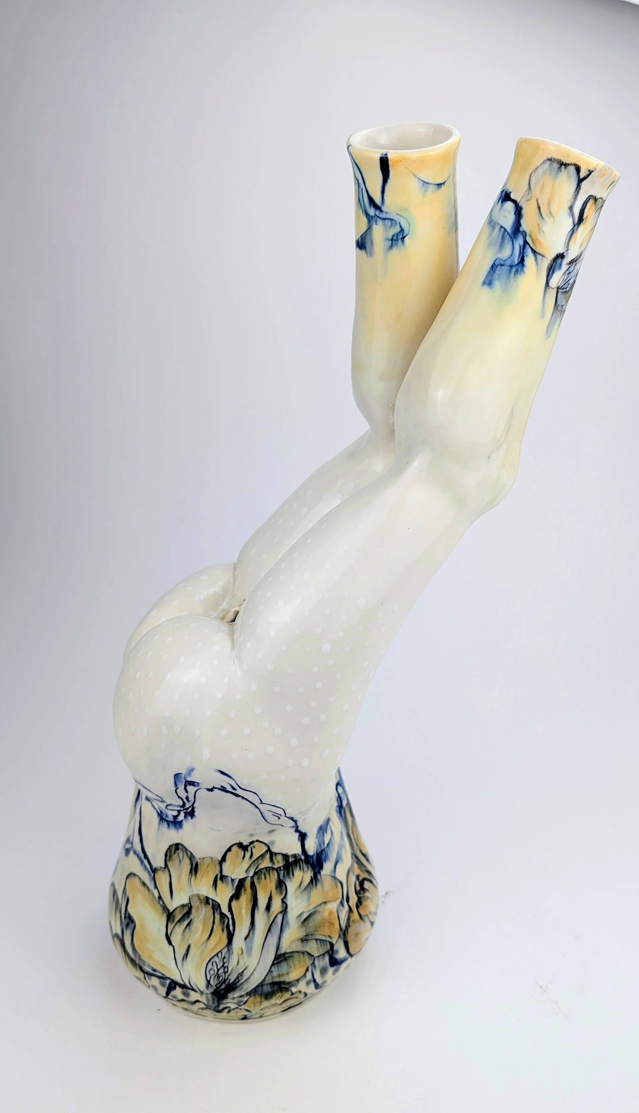 Ceramic sculpture of a pair of legs with painted boots, lying upside down