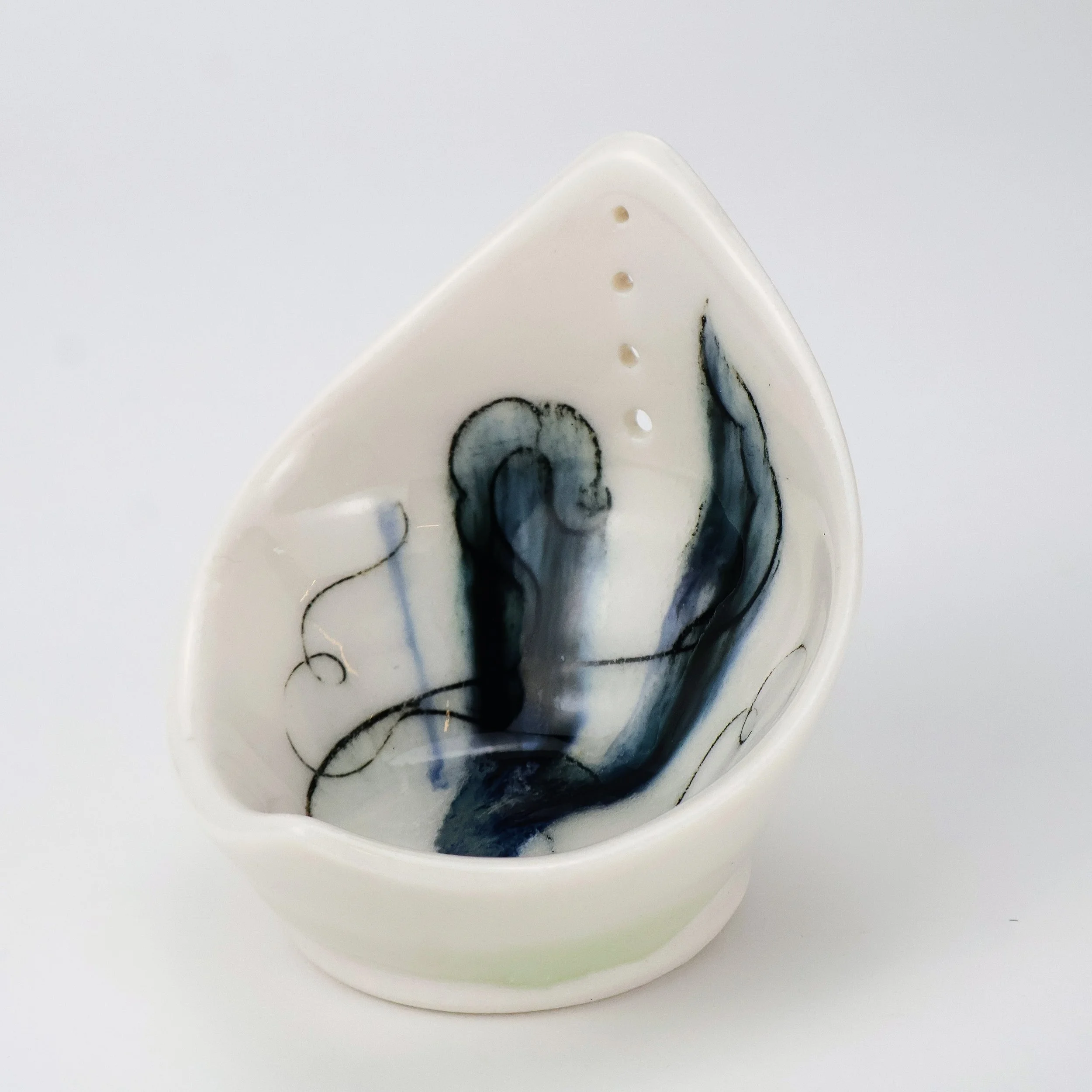 Porcelain ceramic Herb puller with black and gray abstract artistic design inside.