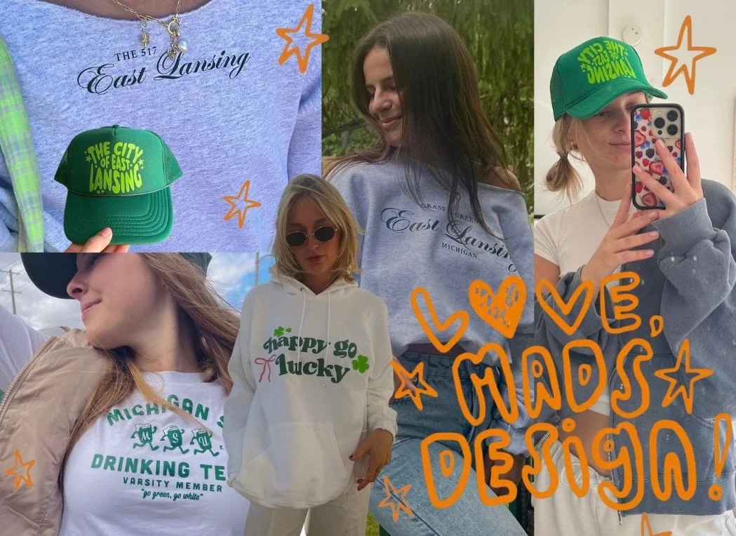 Collage of four women wearing and holding gray and white hoodies and a green hat with yellow text. The hoodies have text referencing East Lansing, Michigan, and include phrases like 'The 517 East Lansing,' 'Happy go lucky,' and 'Michigan Drinking Team.' One woman is taking a mirror selfie, and another is outdoors with sunglasses. There are orange doodles and stars, and the text 'Love, hands design!' written over the collage.