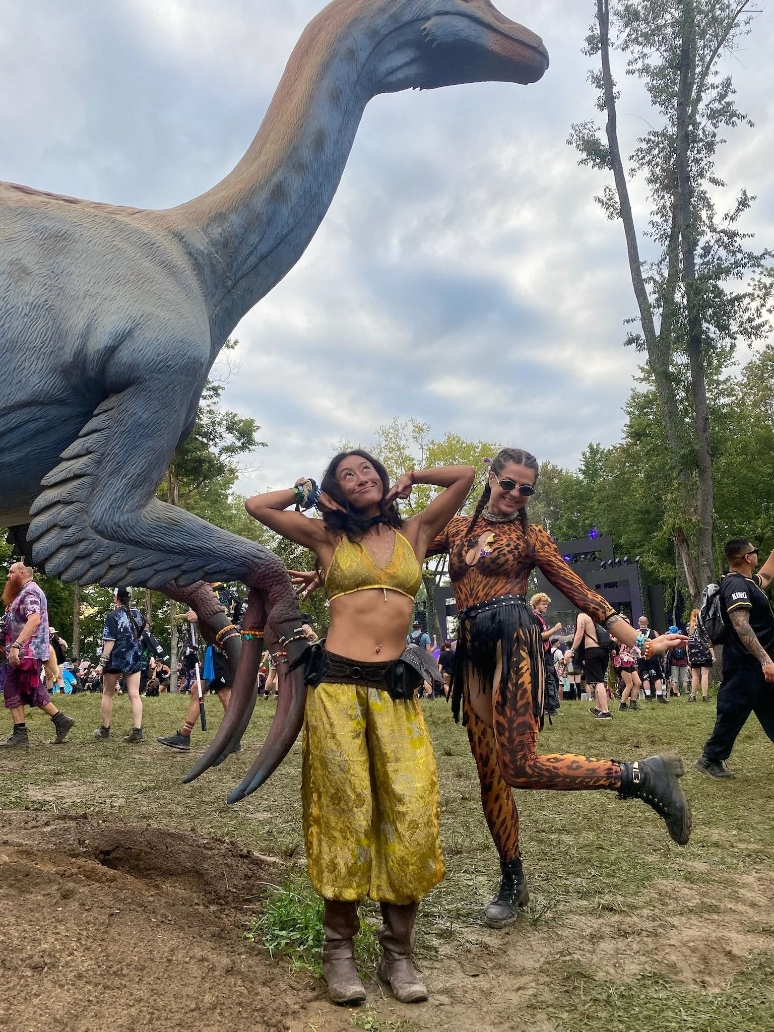 Monica and Amanda posing with a dinosaur at Lost Lands festival