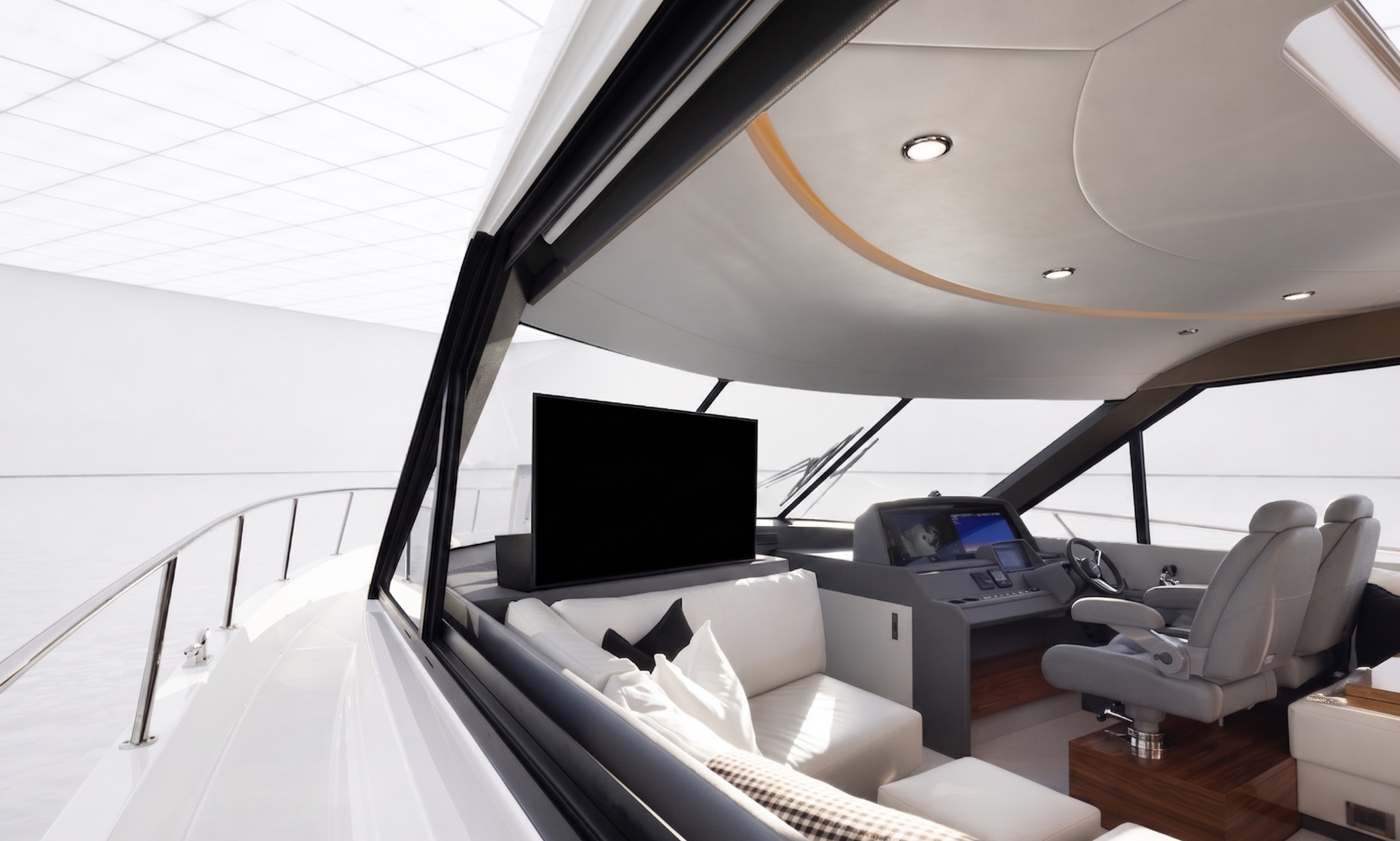The interior of a luxury yacht with a modern design, featuring a white leather sofa, a flat-screen TV, navigation controls, and panoramic windows showing the ocean.