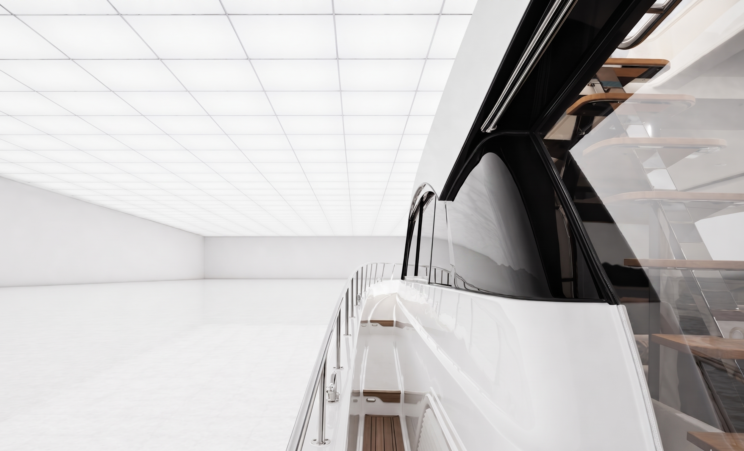 Interior of a yacht with a sleek black front window, white walls, and wood accents on the stairs and handrails.