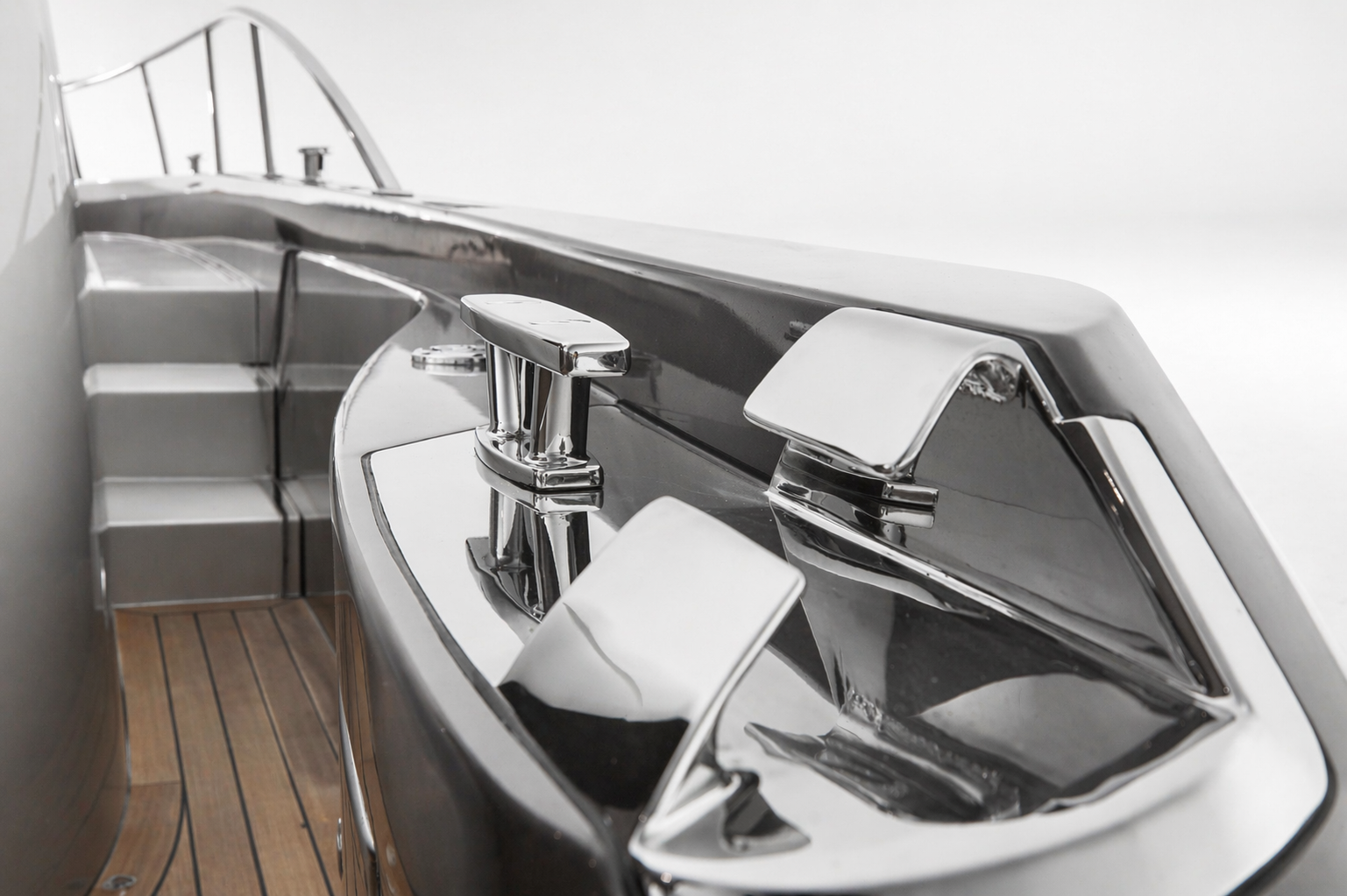 Close-up of a yacht's sleek, reflective metallic surface with polished metal fixtures and wooden deck.