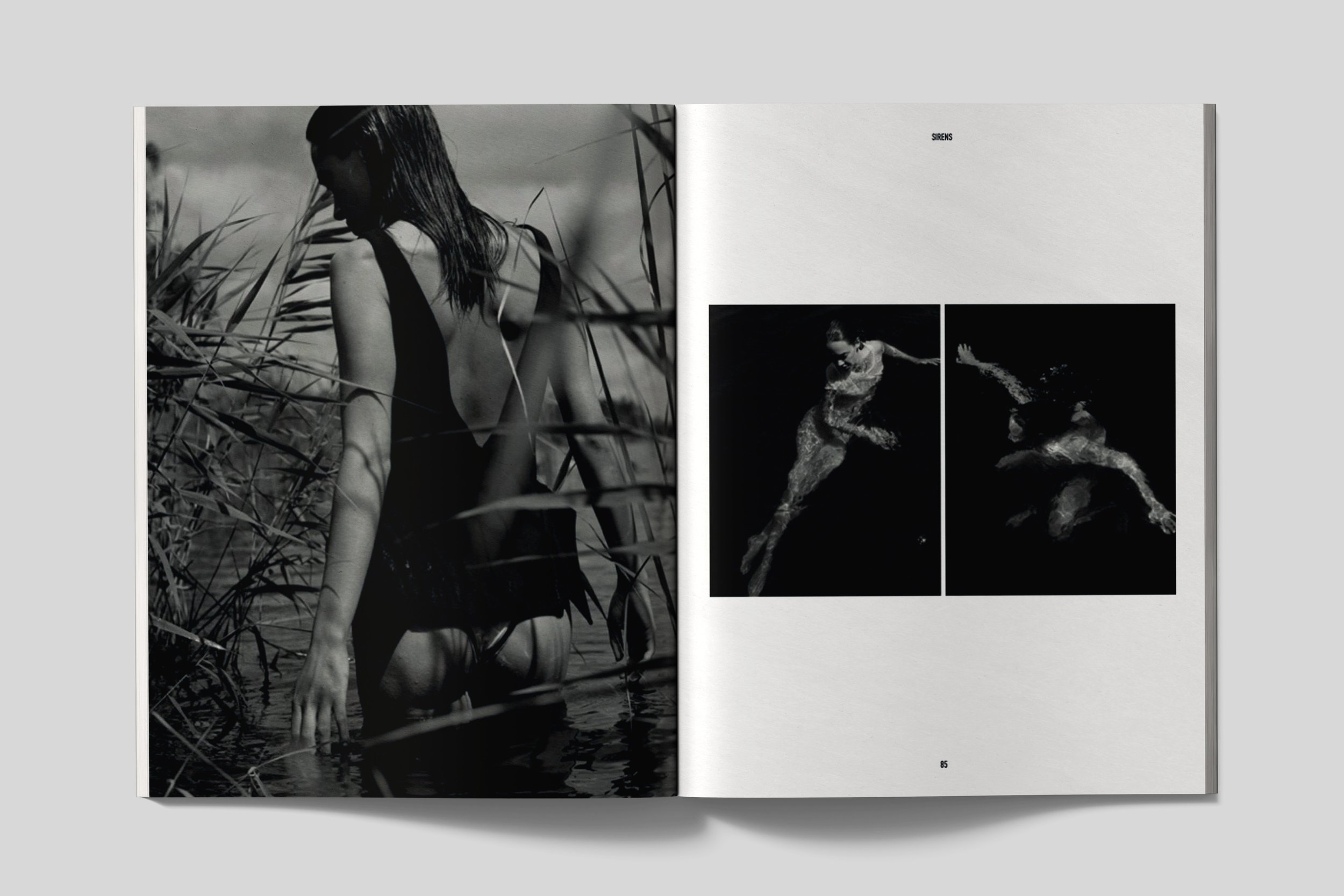 Open book showing black and white photographs of women in aquatic and natural settings, one standing among tall grasses, and others swimming.