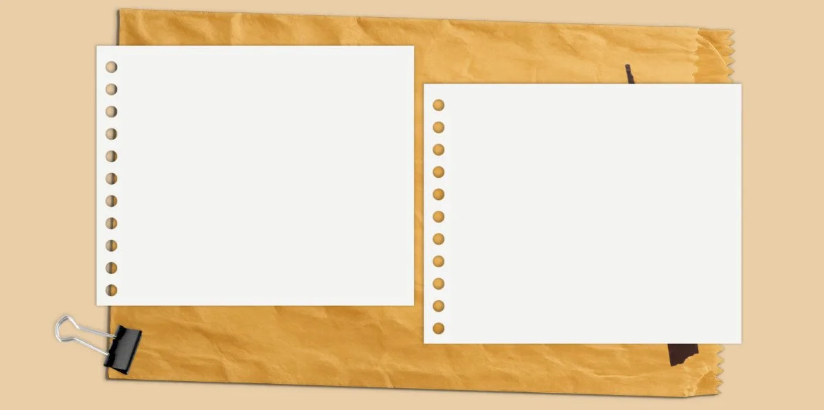 Two sheets of white perforated paper on a wooden board, clipped at the bottom left corner, with a torn piece of brown paper underneath.