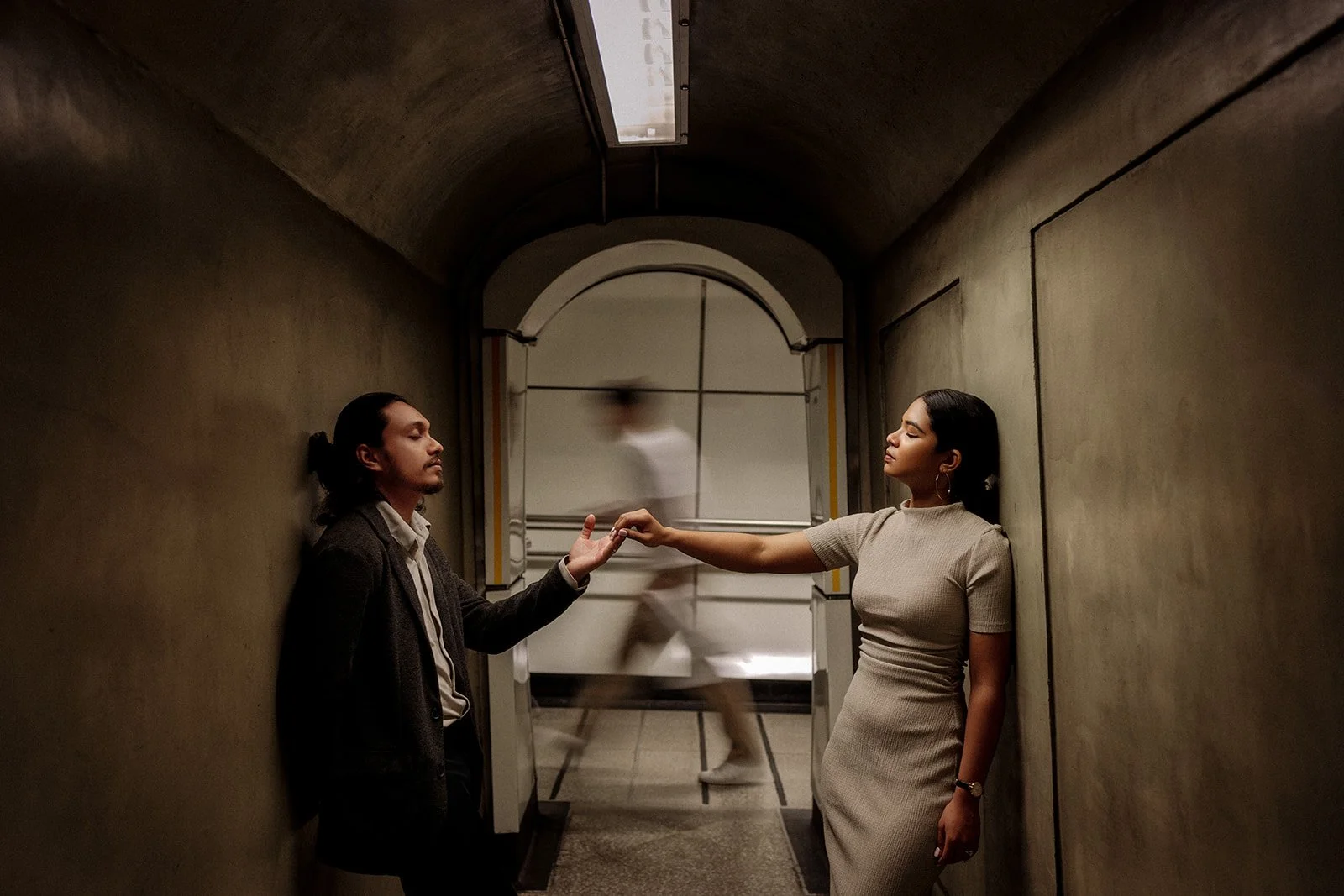 A photograph of a couple in the metro station, having a moment